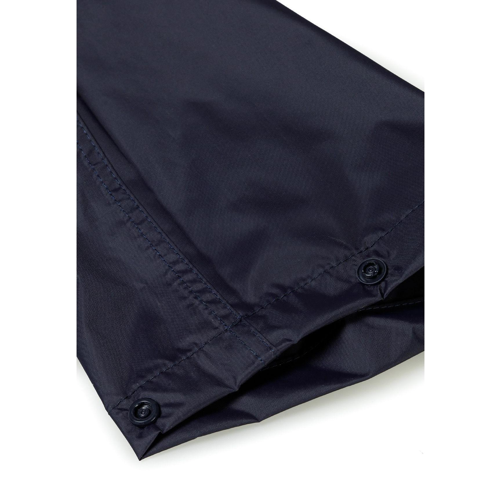 Detail shot of navy waterproof fabric showing reinforced seam stitching and weather-resistant construction