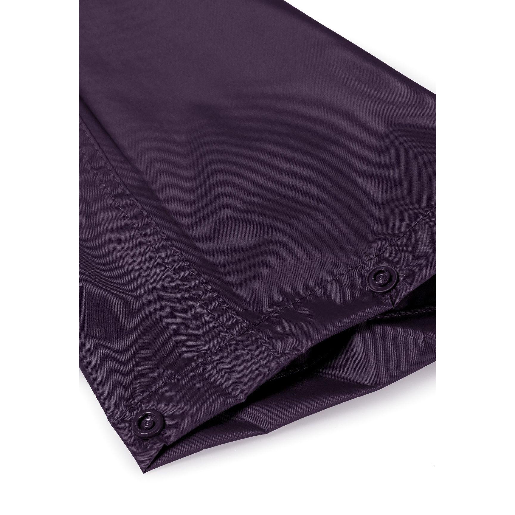 Close-up detail of purple waterproof fabric showing seam construction and material texture, highlighting quality stitching and waterproof properties