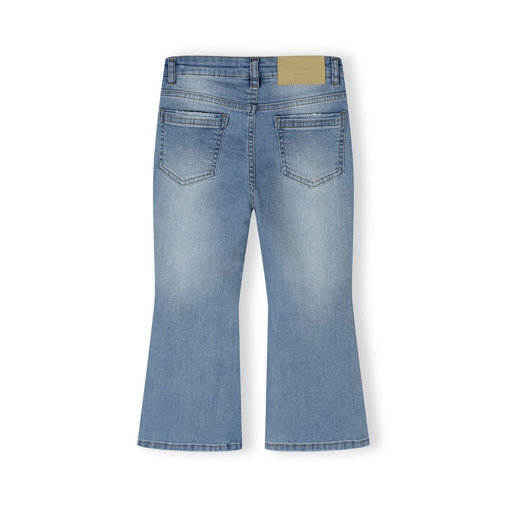Navy denim flare jeans laid flat showing back view with brown waistband label and classic five-pocket styling
