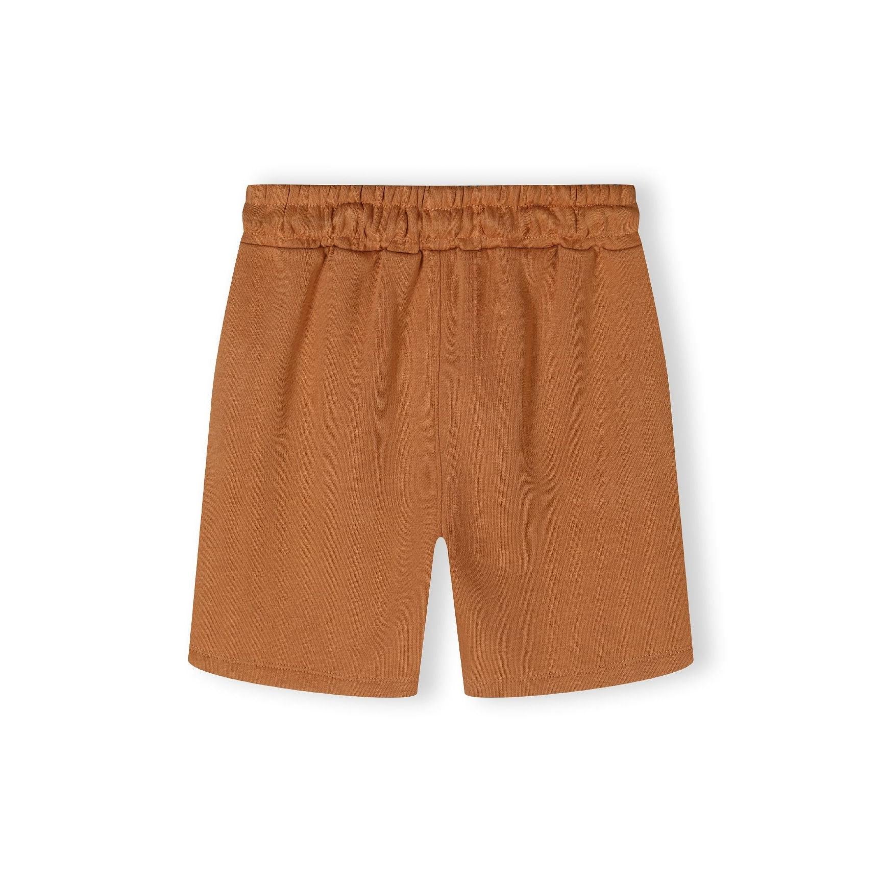 Close-up detail of camel brown shorts showing elasticated waistband with drawstring ties and soft jersey texture