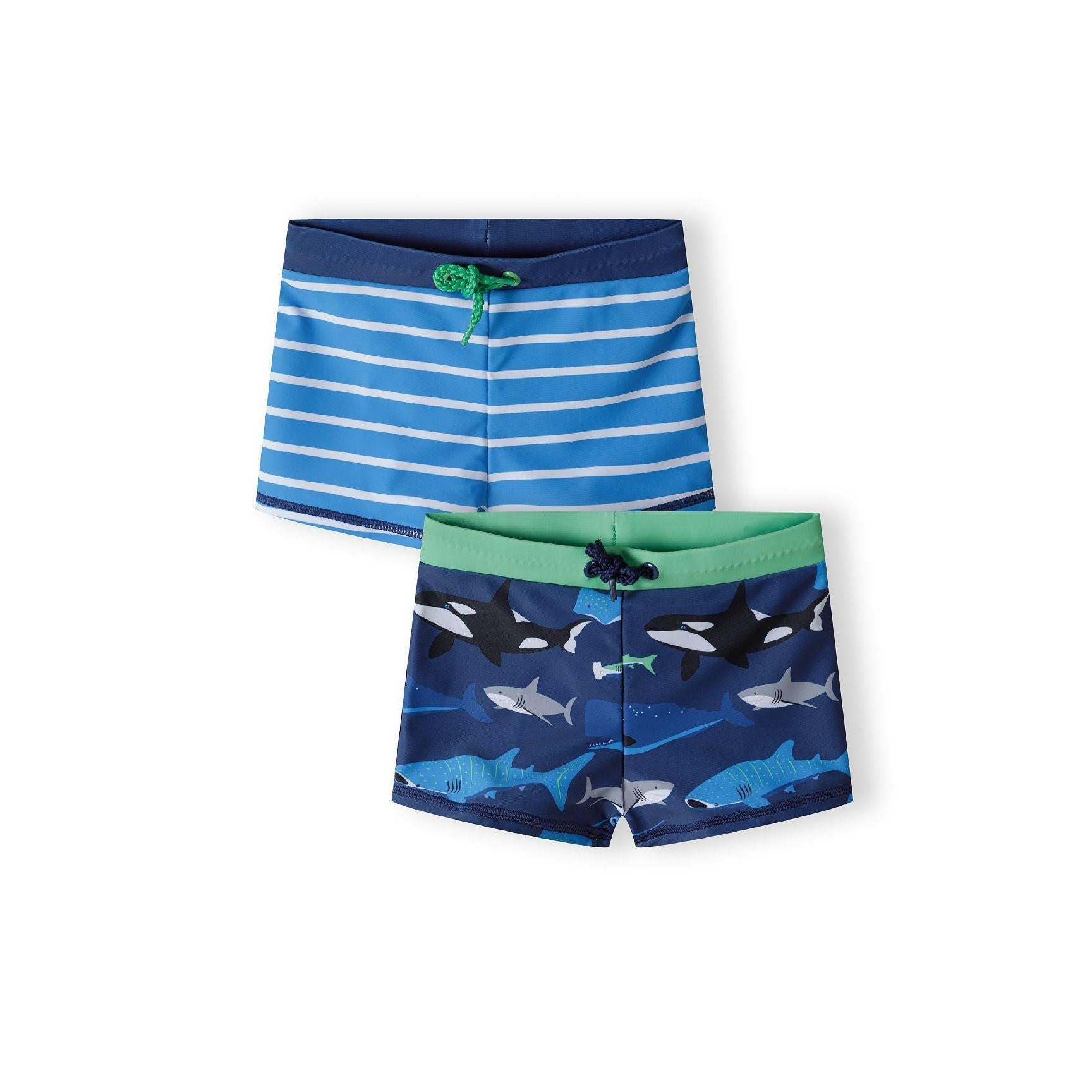 Two navy rash shorts laid flat showing striped design with blue and white stripes and sea creature print with sharks and marine life