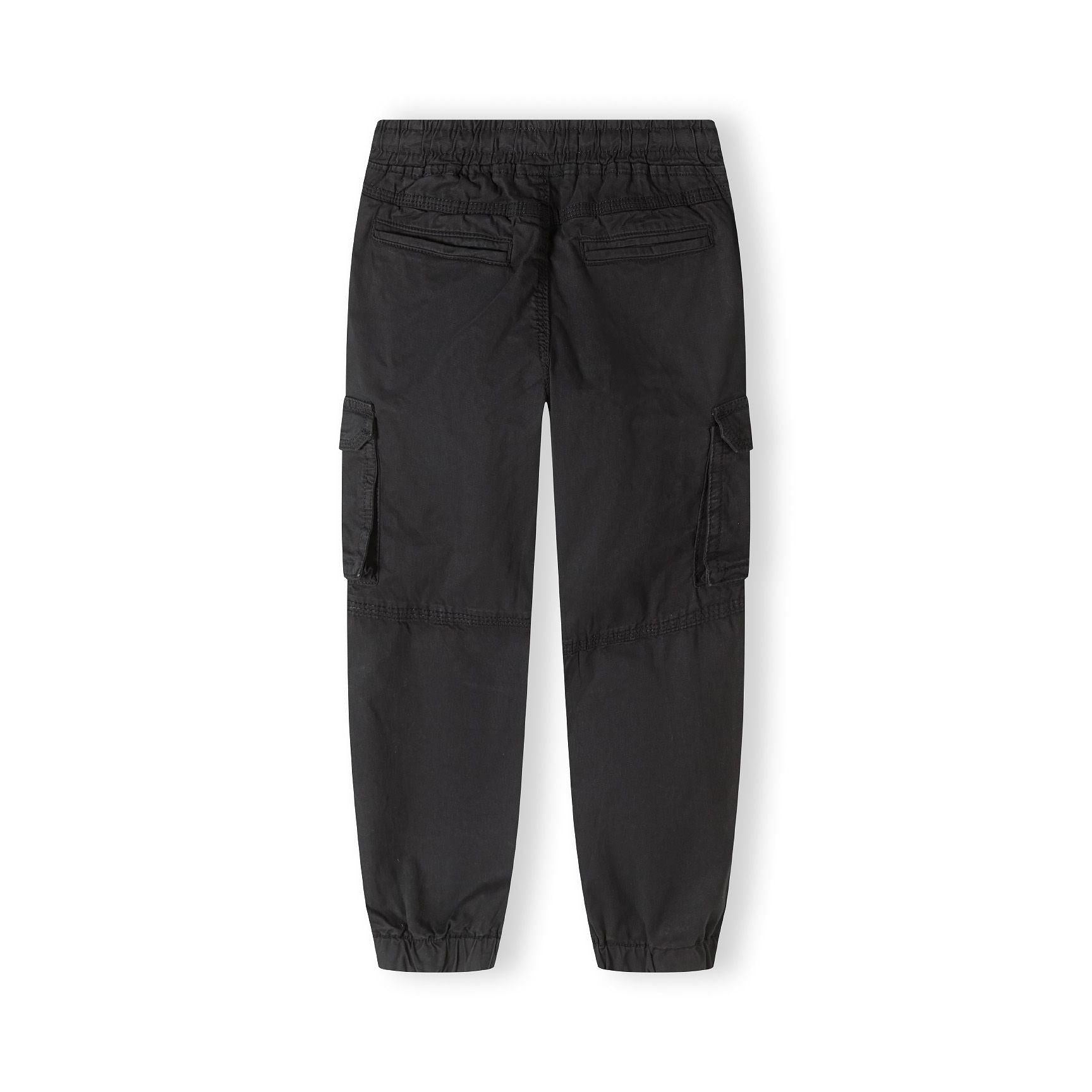 Back view of black cargo trousers showing elasticated waistband, cargo pockets on sides and tapered leg shape on white background