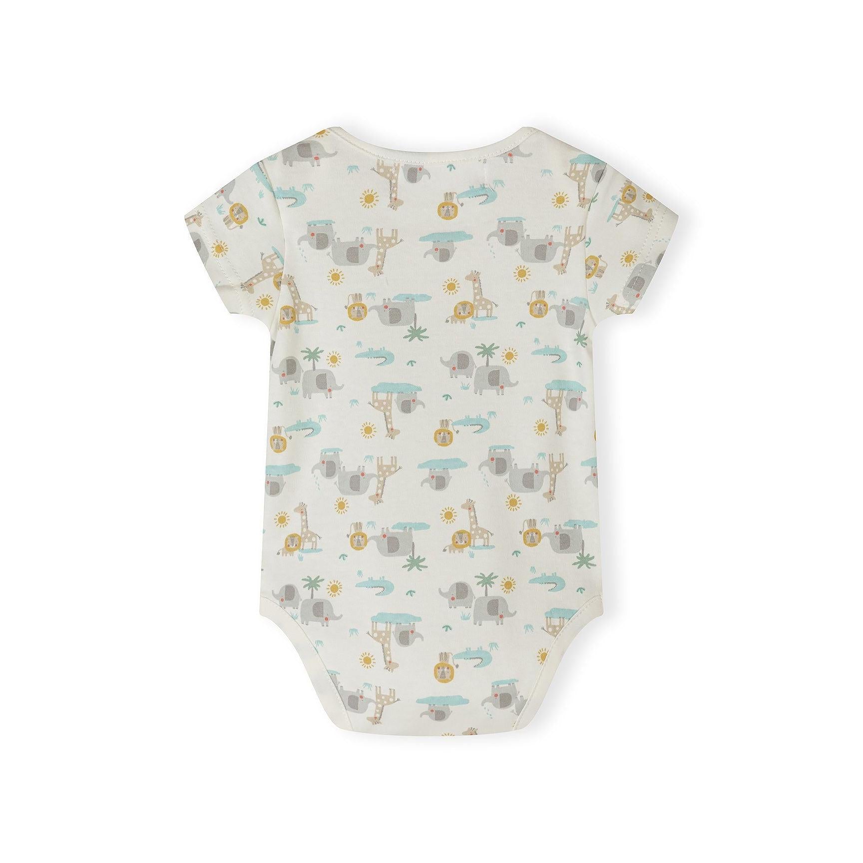 Close-up detail of cream bodysuit with colorful polka dots and safari print showing elephant, giraffe, lion, palm tree and 'Hello jungle FRIENDS' text with sun design