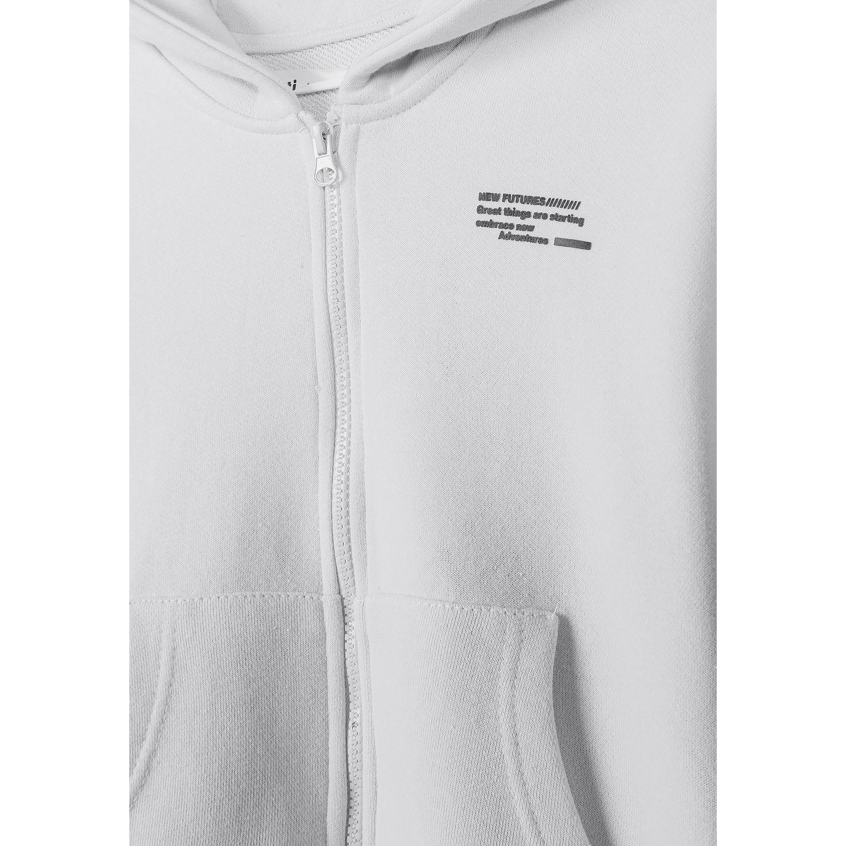 Close-up detail view of white hoodie showing front zipper area, small chest logo text, and kangaroo pocket construction against white background