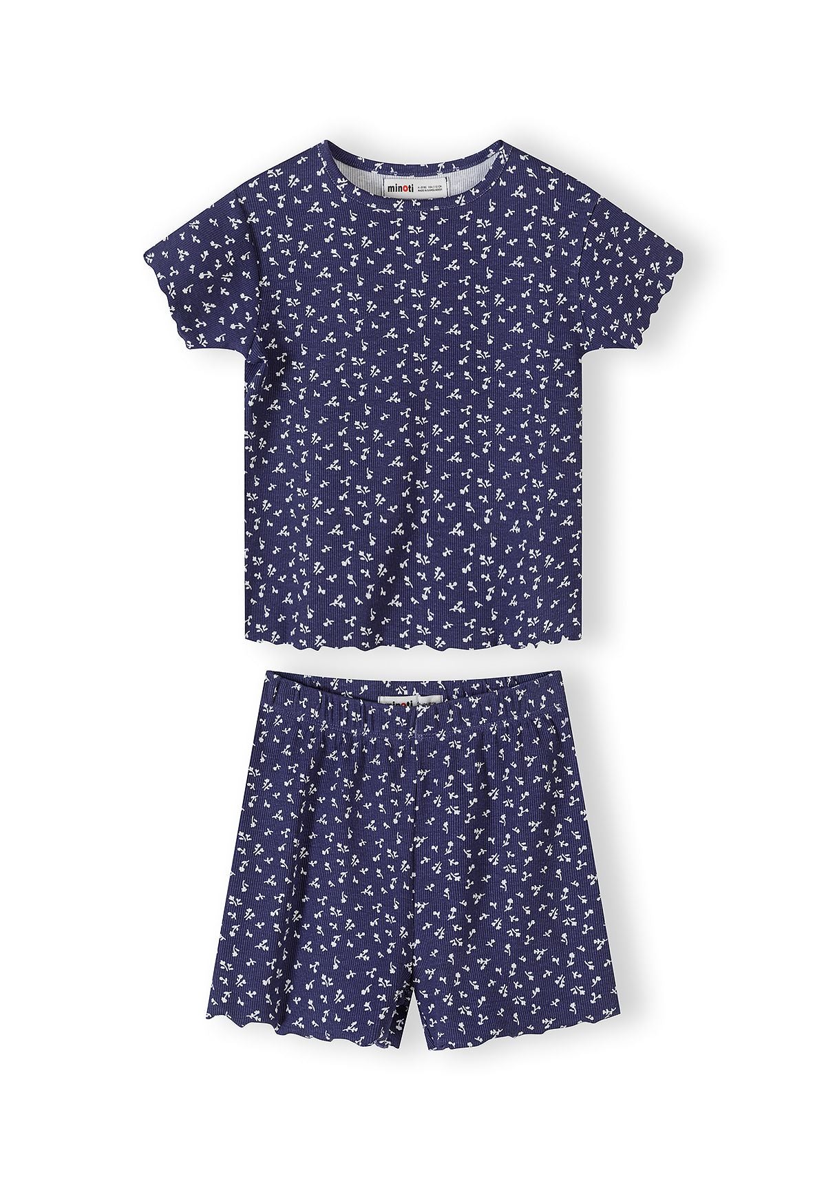 Navy pyjama set with white floral print showing short sleeve top and matching shorts with scalloped edges on white background