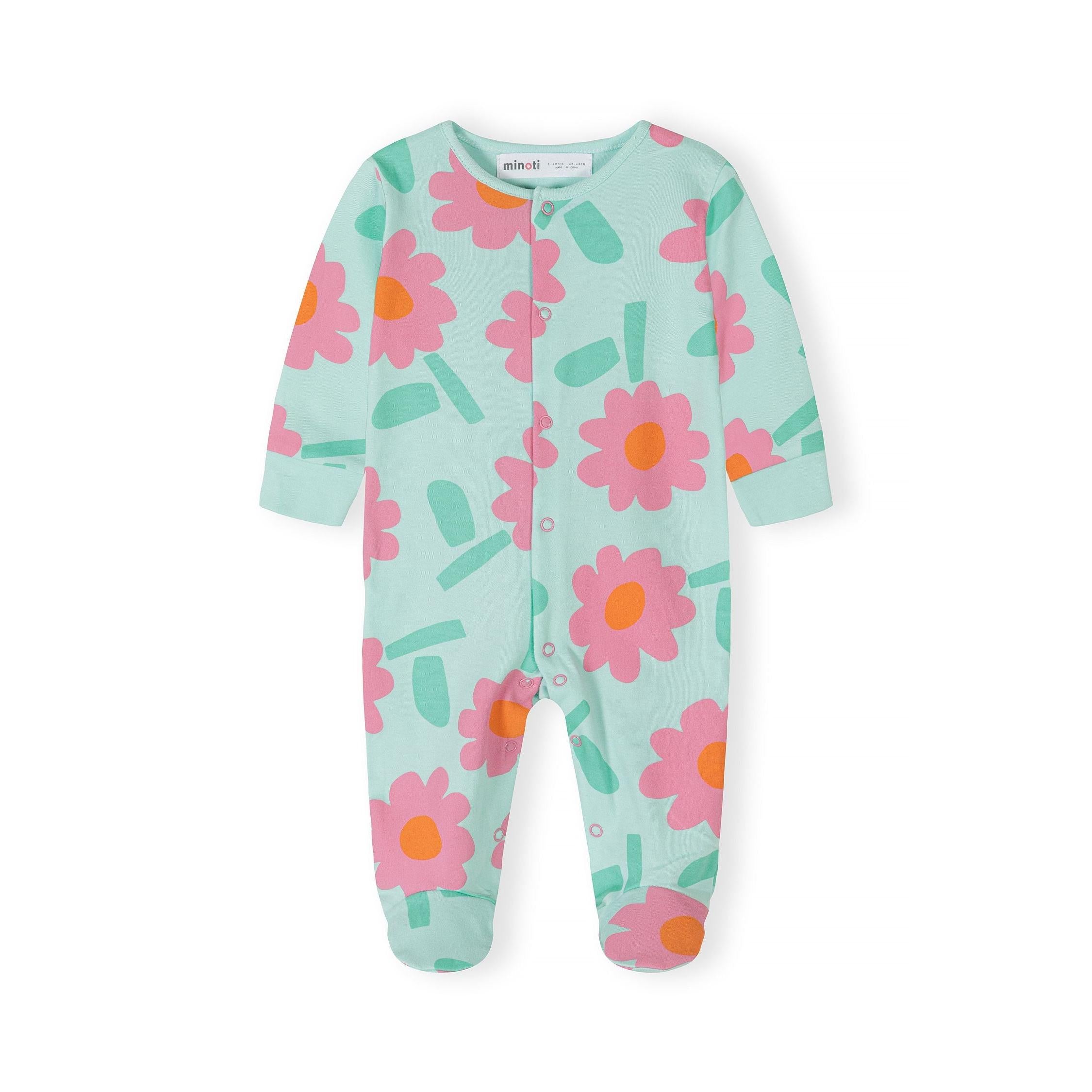 Close-up of mint green sleepsuit with pink and orange floral pattern and matching ribbed cuffs, showing front button closure