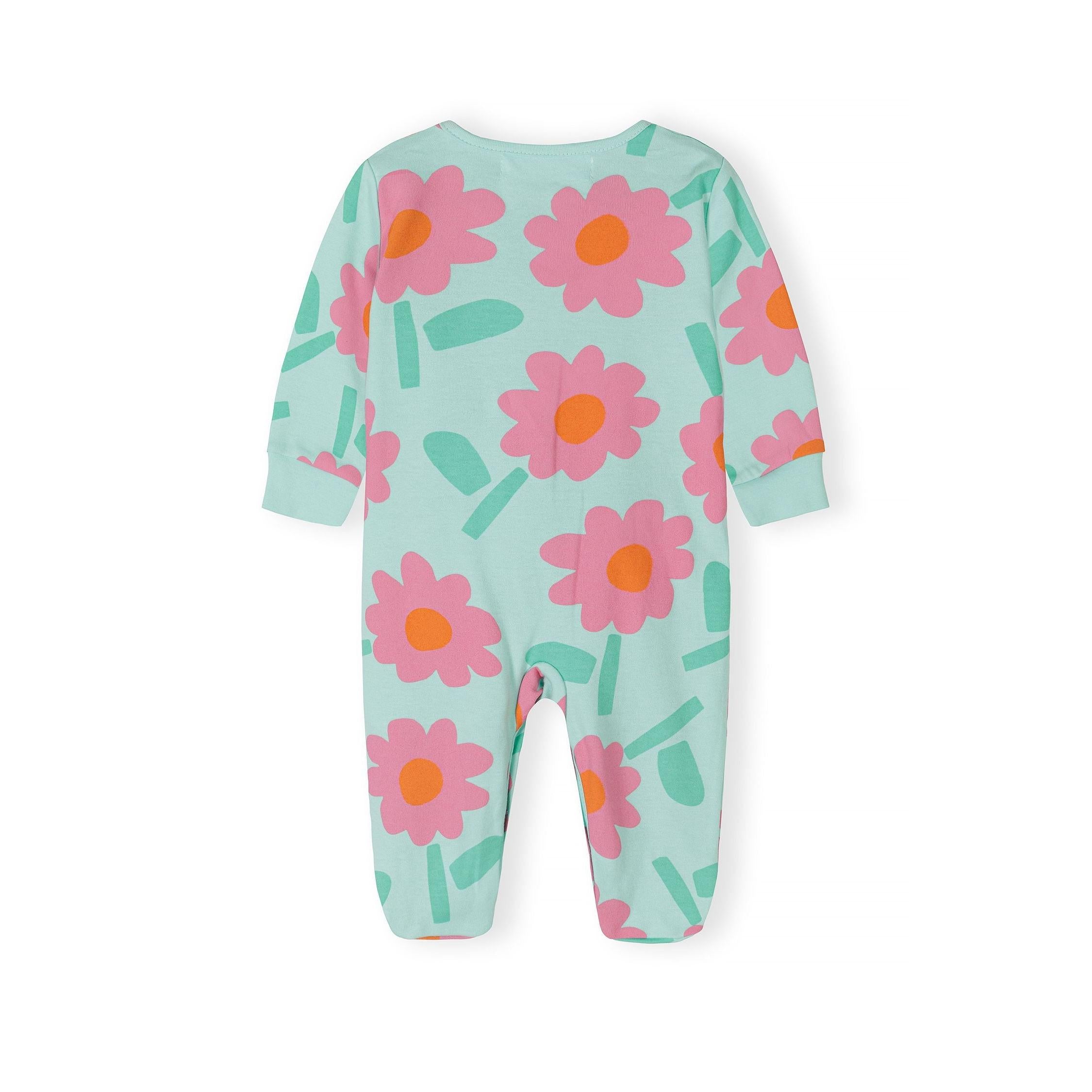 Detail shot of light blue polka dot sleepsuit showing Minoti label, press stud fastening and embroidered yellow sun with orange flower appliqués