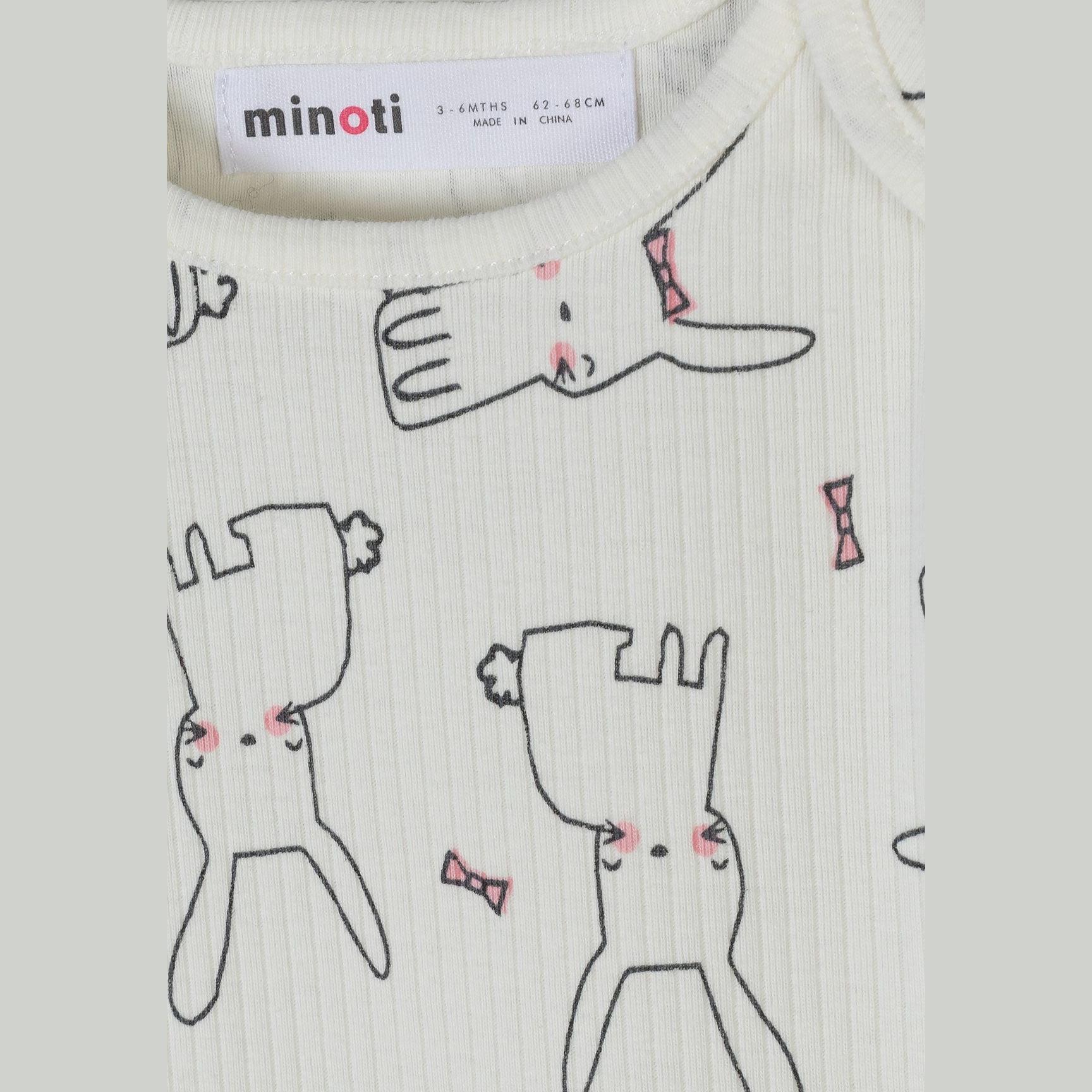 Close-up detail of white bodysuit showing Minoti label and cute rabbit illustrations with pink bow ties