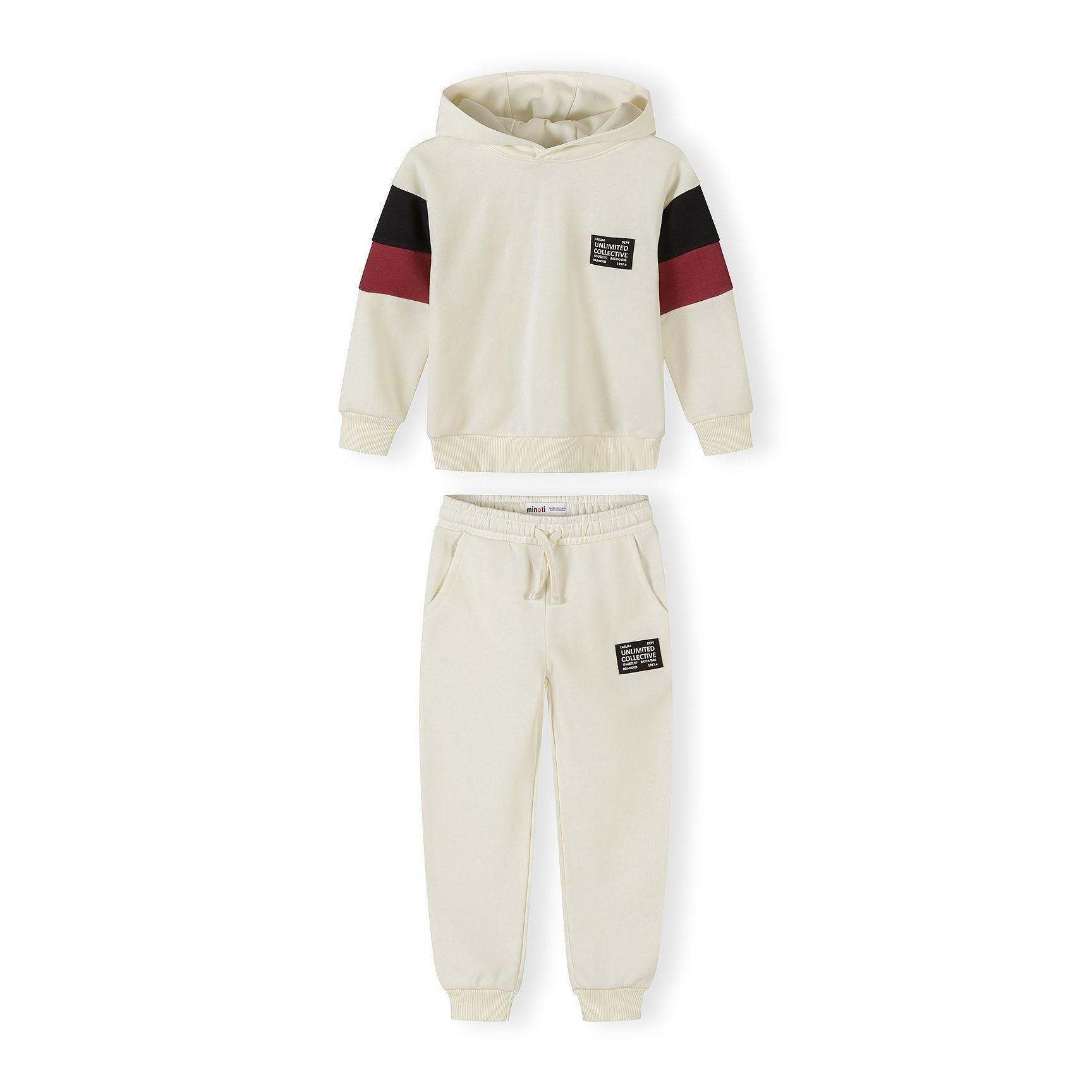 Cream tracksuit set with hooded sweatshirt and joggers featuring black and burgundy contrast panels on sleeves, displayed flat on white background
