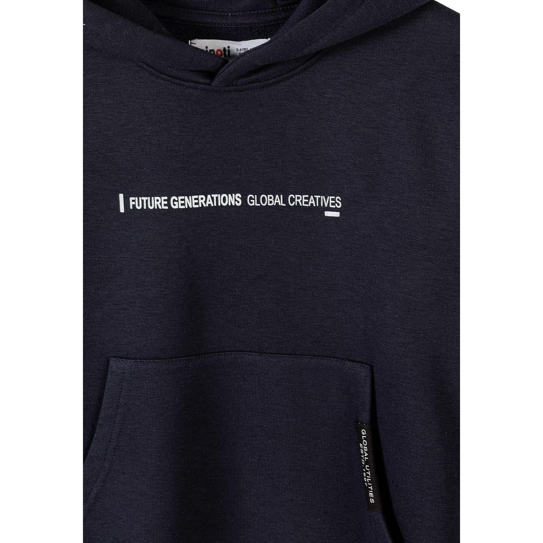 Detail view of black joggers showing drawstring waistband and vertical text print on the leg against white background