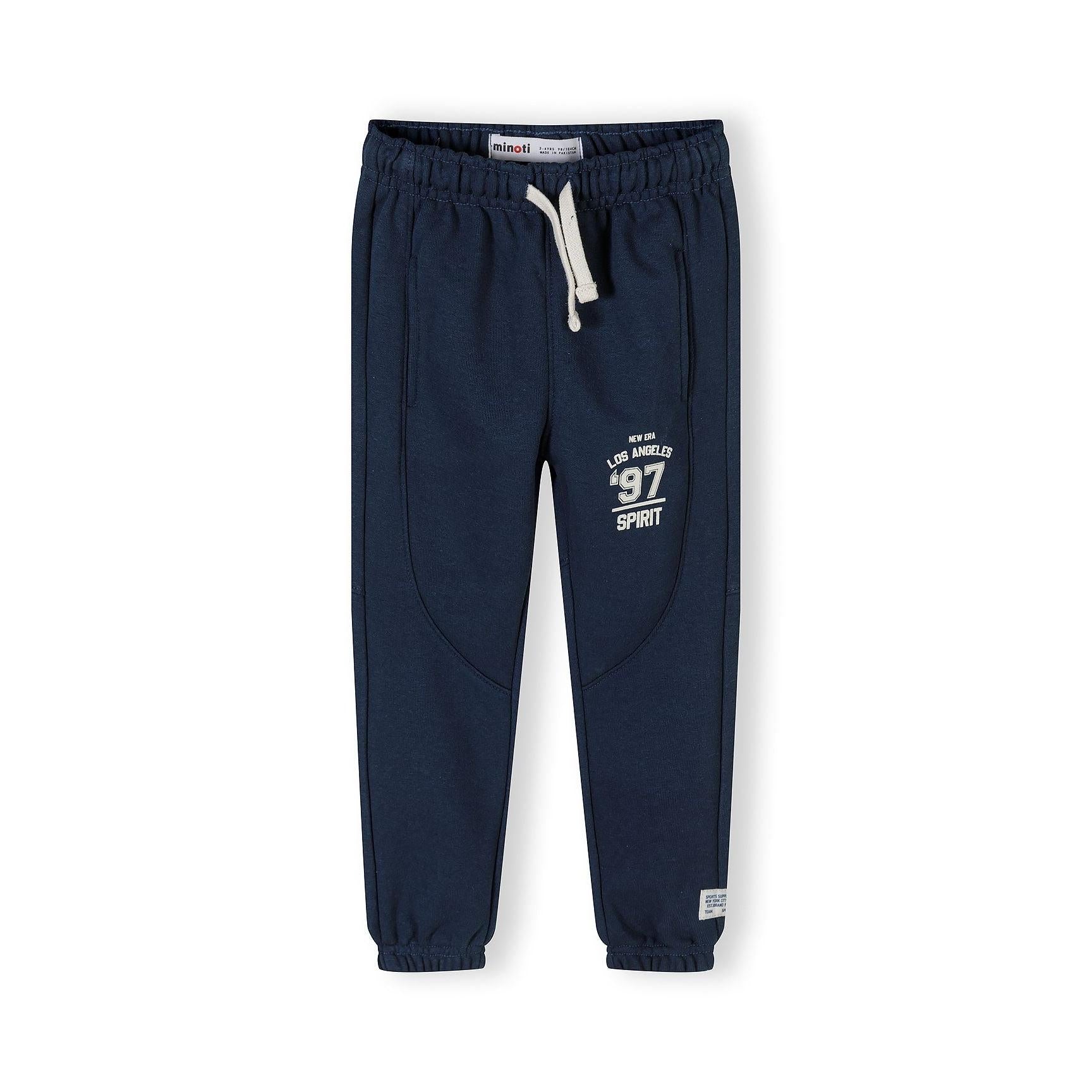 Close-up detail of sweatshirt chest area showing NYC State 1997 Sports Hero print in navy lettering on cream fabric with green neckline