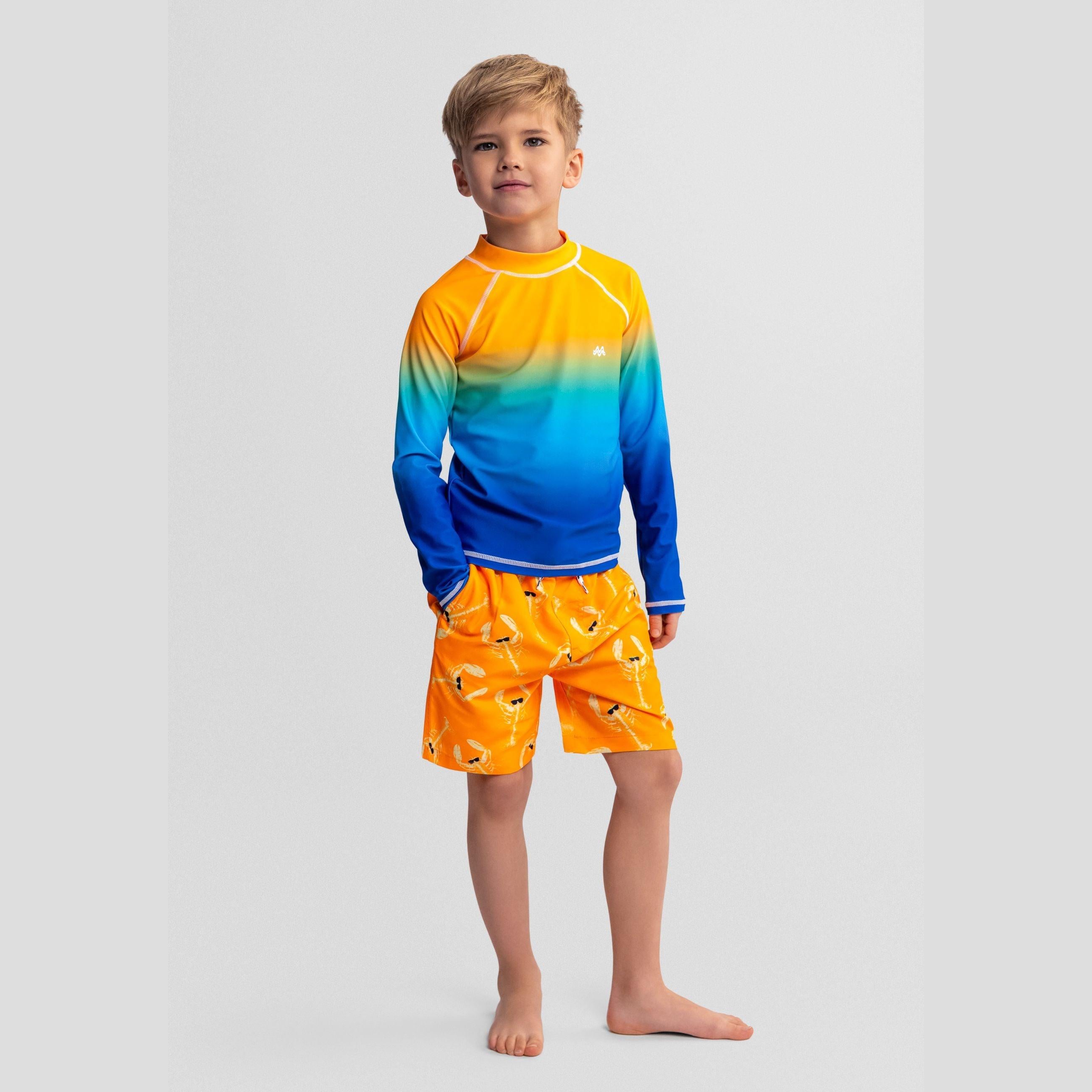Single orange to blue gradient long sleeve swim t-shirt laid flat on white background showing ombre color transition and raglan sleeves