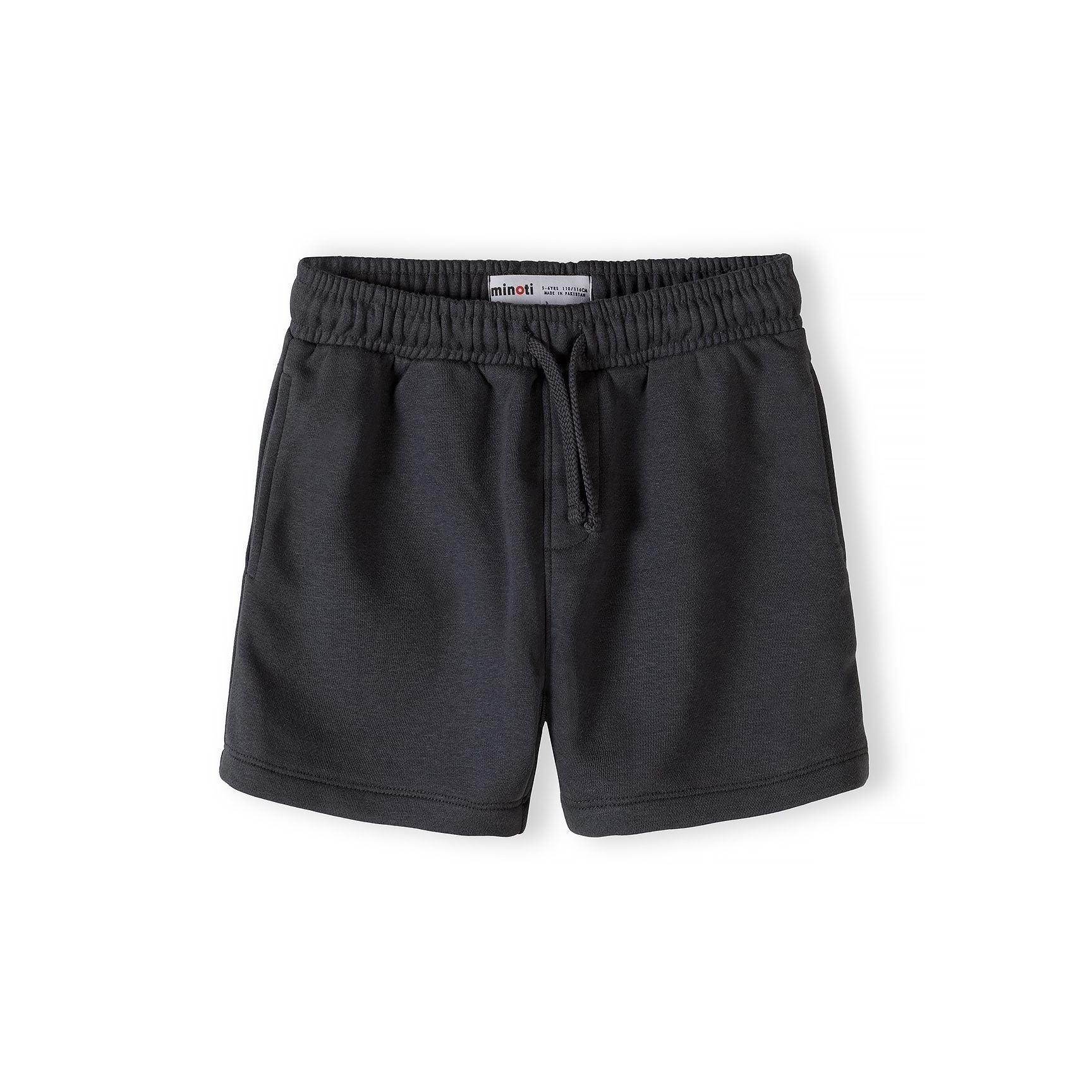 Close-up detail of urban collection patch on grey t-shirt featuring geometric cube logo and text