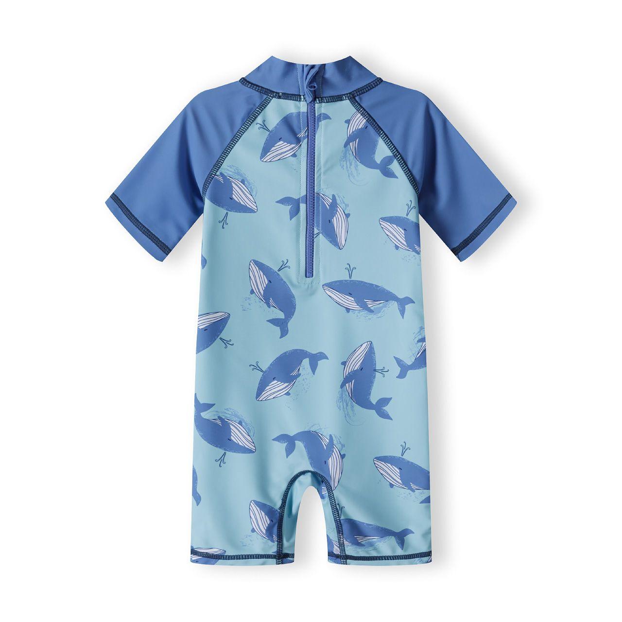Back view of whale print sunsuit showing half zip closure and contrasting blue raglan sleeves on white background