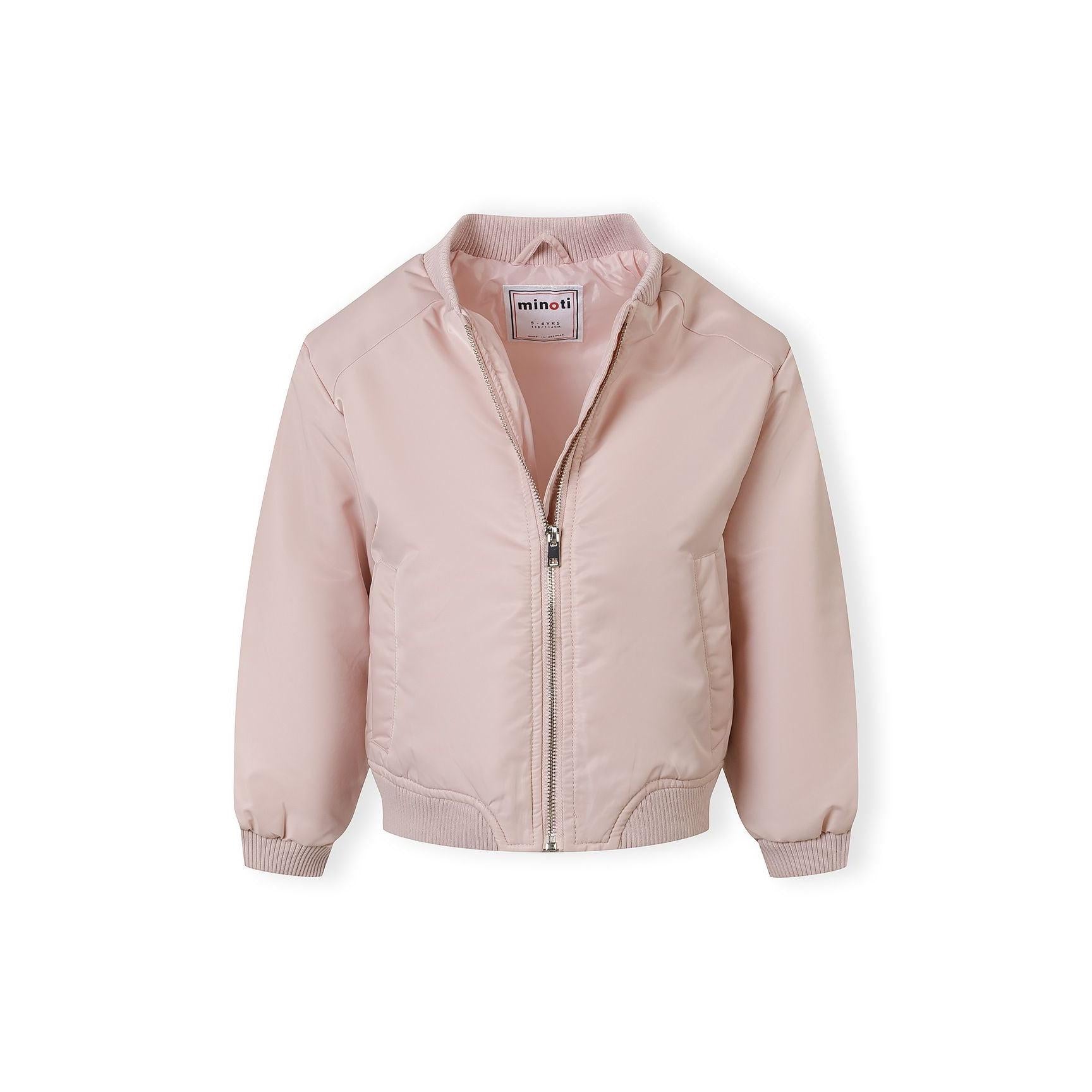 Close-up detail of pink quilted bomber jacket showing rectangular chest pocket with stitched edges and quilted nylon fabric texture