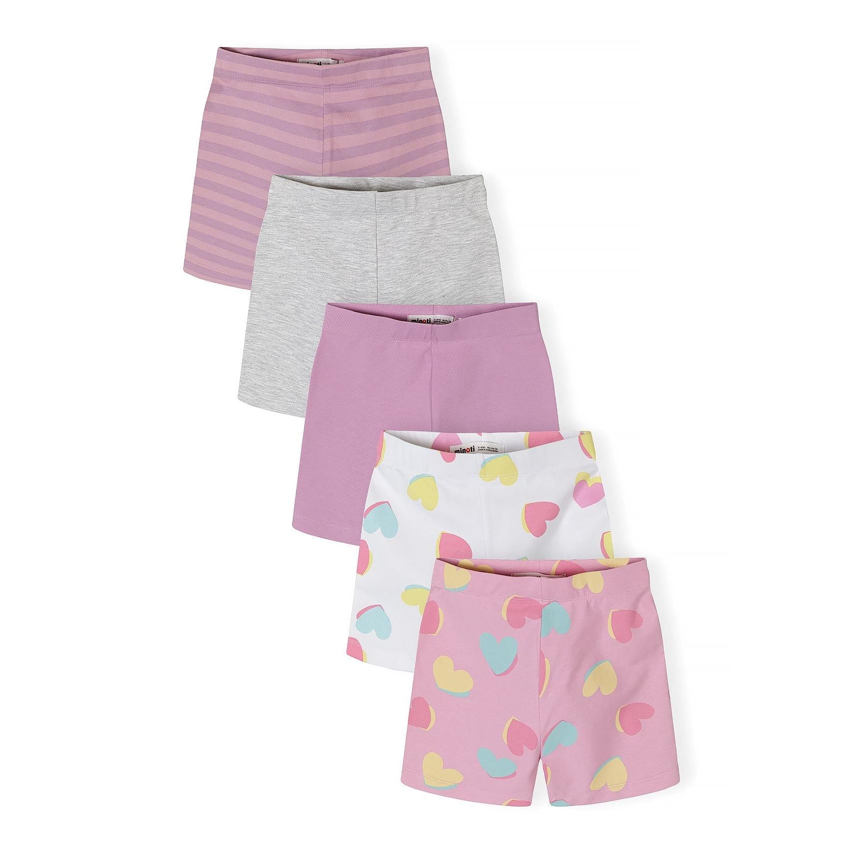 Five cycle shorts laid out in fan arrangement showing lilac striped, grey melange, solid lilac, white with colorful hearts, and pink with heart print designs