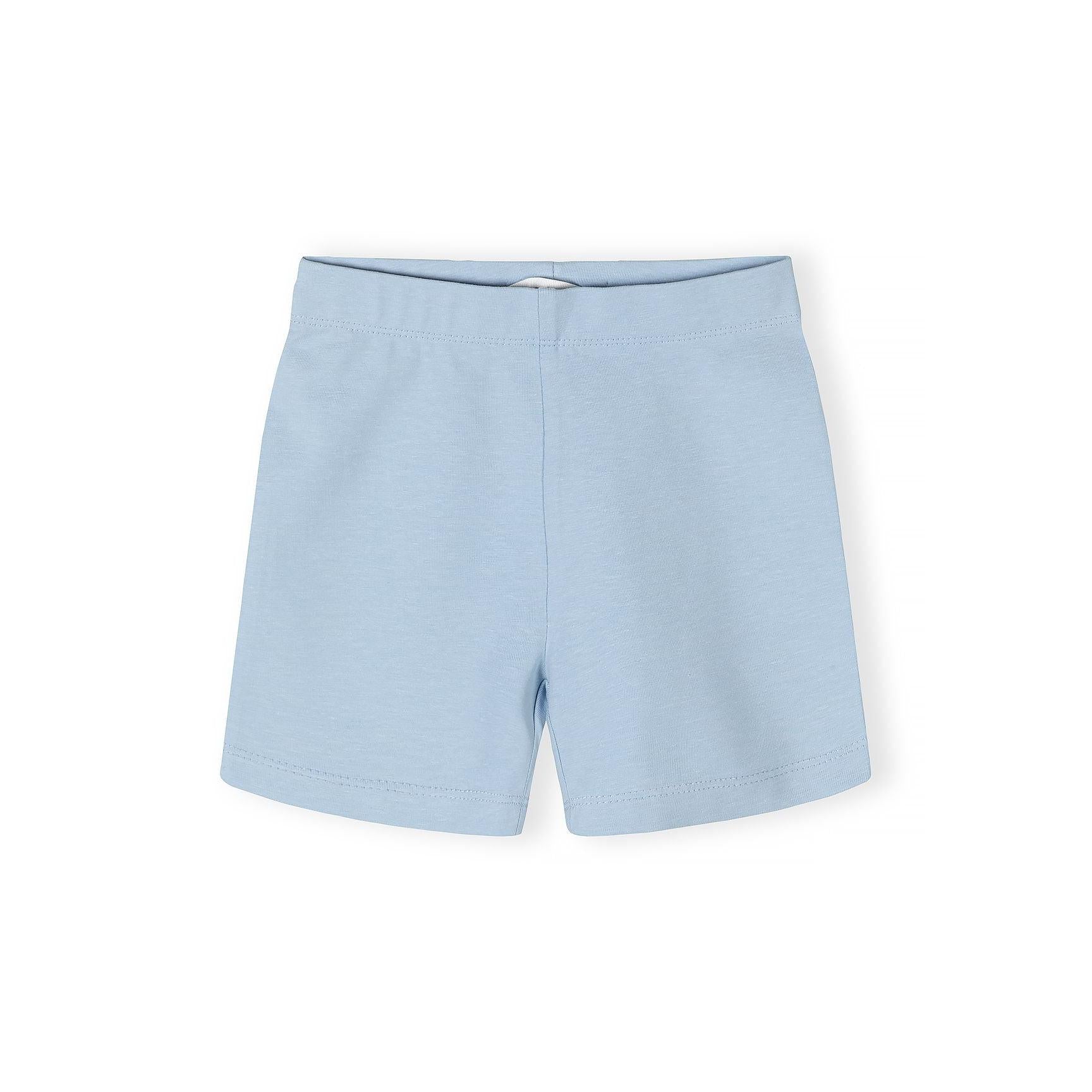 Close-up detail of light blue unicorn print fabric showing colourful unicorns, rainbows, flowers, and decorative elements on soft blue background