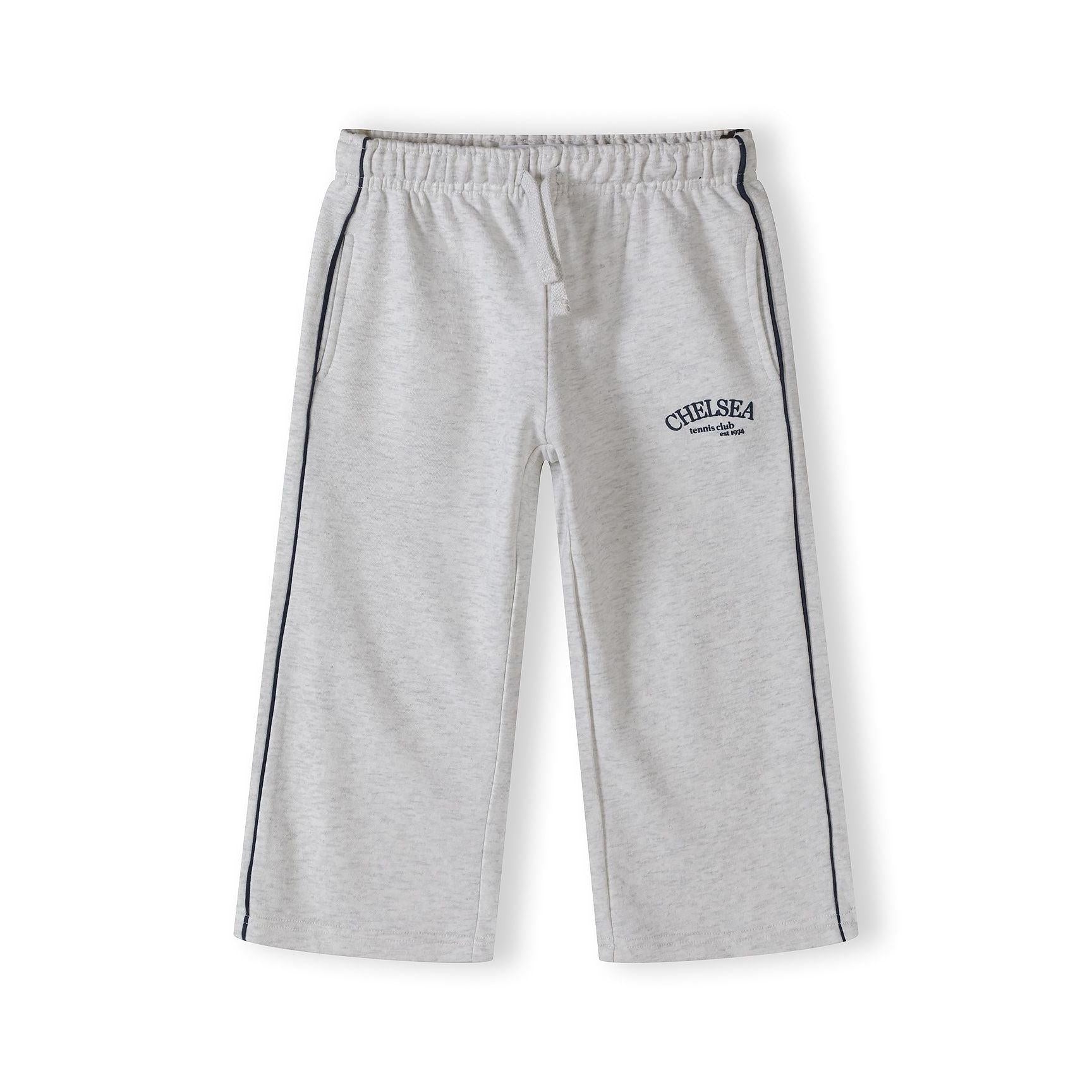 Close-up detail of grey marl joggers showing Chelsea team club est 1924 embroidery and black side piping on white background