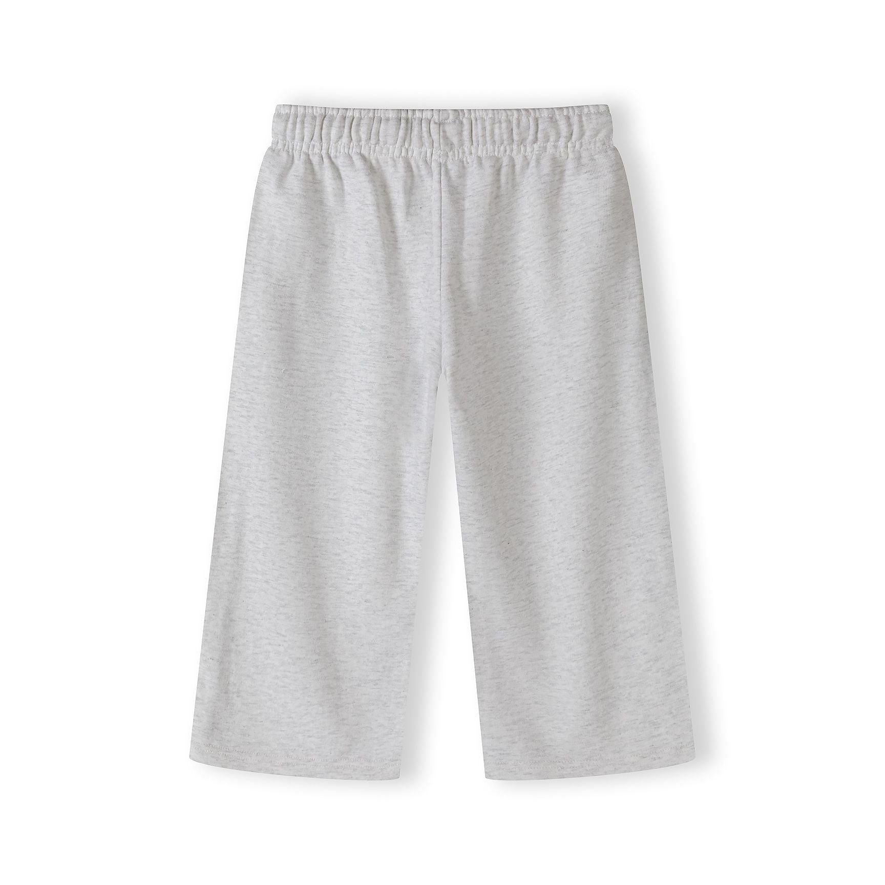 Close-up detail of grey marl joggers showing Chelsea team club est 1924 embroidery and black side piping on white background