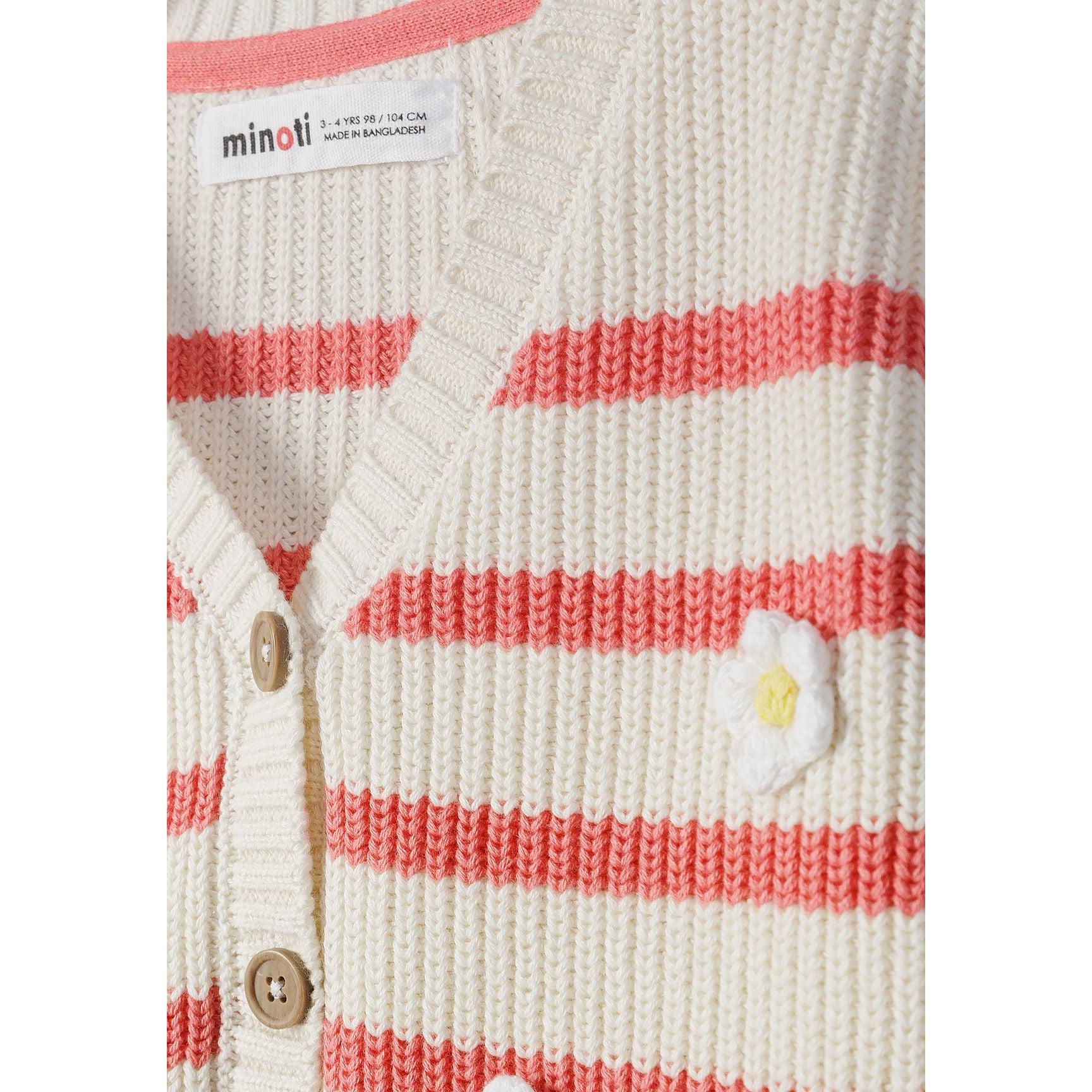 Close-up detail of coral and white striped cardigan showing ribbed knit texture, wooden buttons and white daisy embroidery