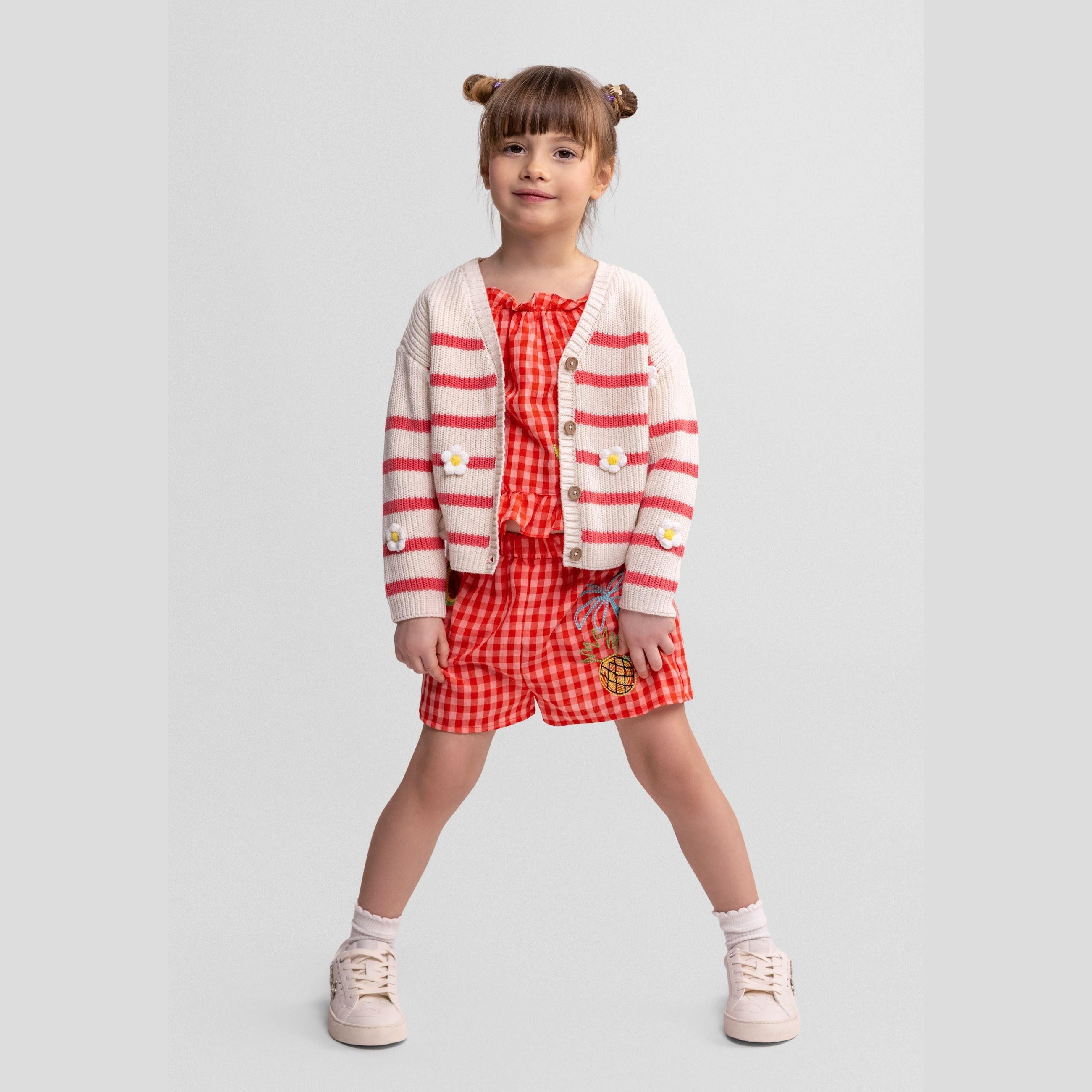 Coral and white striped cardigan laid flat showing button-front closure and daisy embroidery details