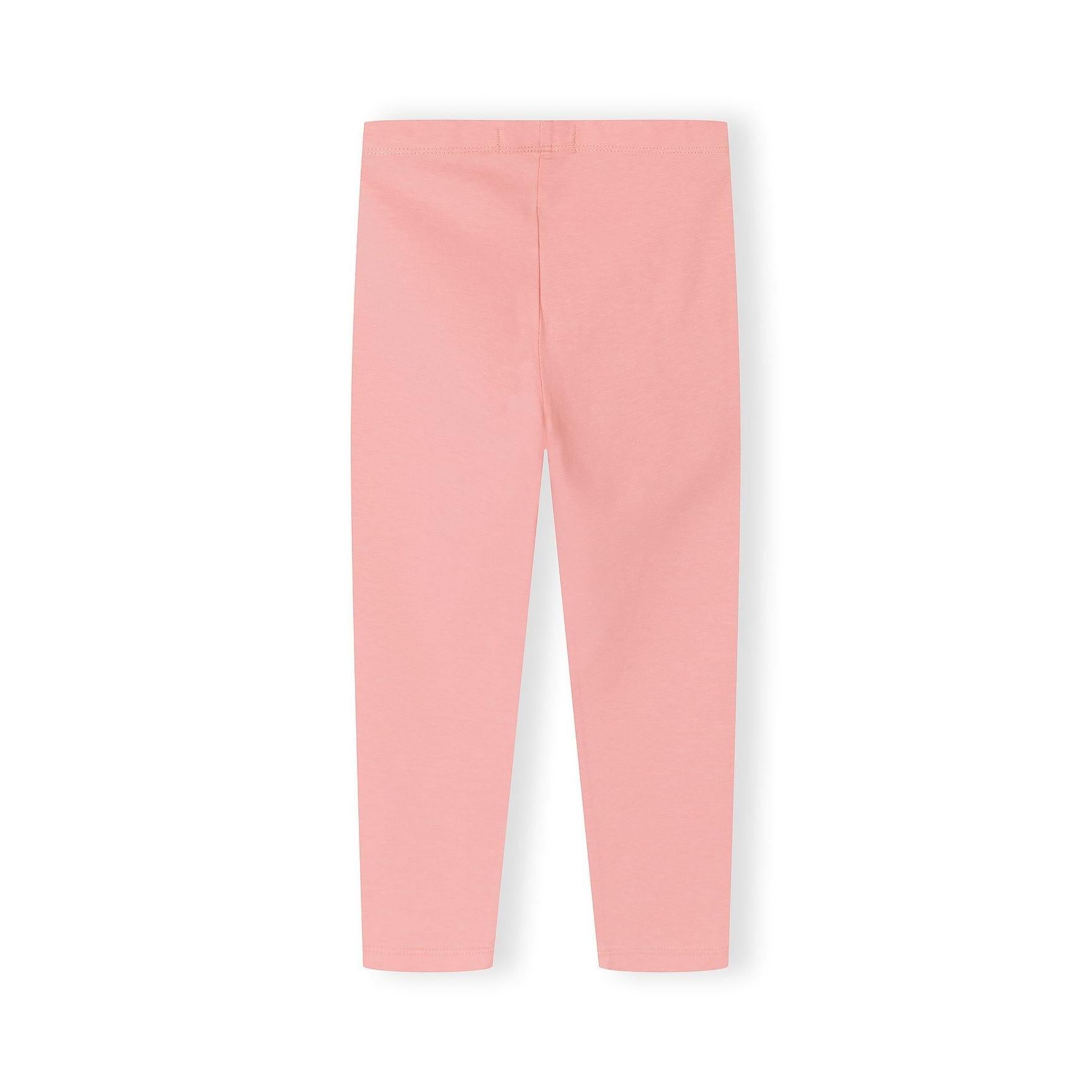 Close up detail of coral pink leggings showing soft fabric texture and comfortable elastic waistband construction
