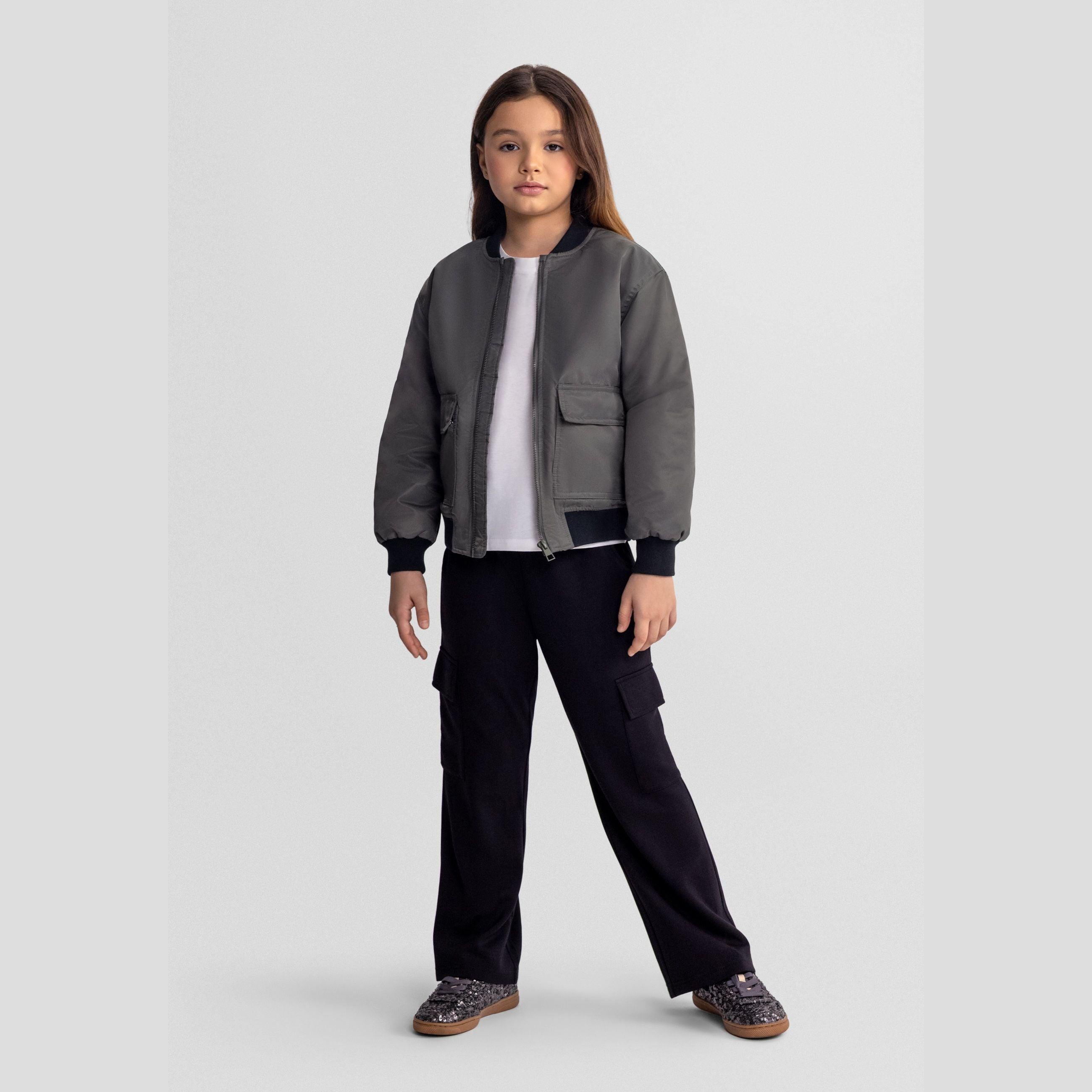 Flat lay of black wide leg joggers showing full silhouette with cargo pockets on sides and elasticated waistband with drawstring