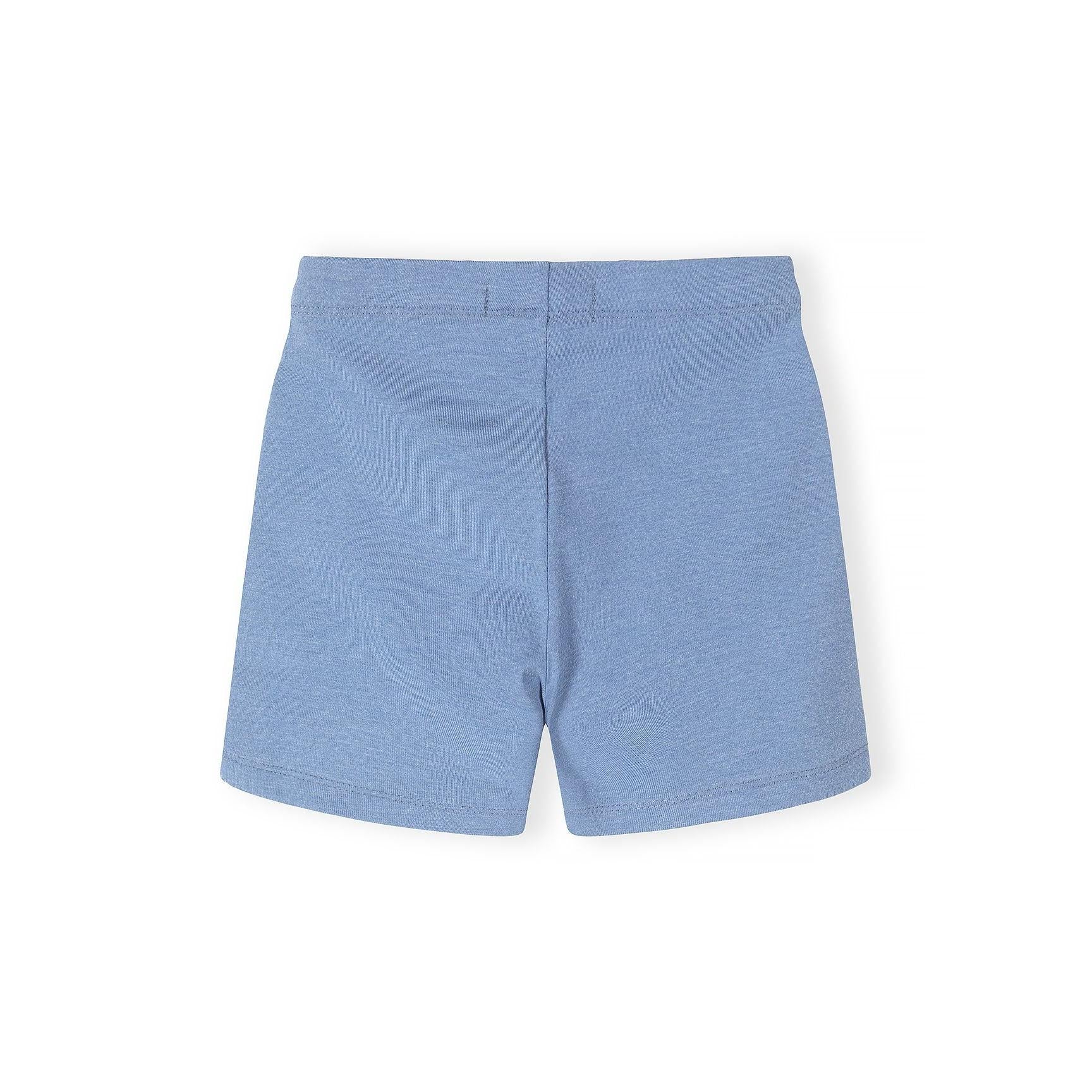 Close-up detail of blue cycling shorts showing fabric texture, stitching quality and Minoti label with brand name clearly visible