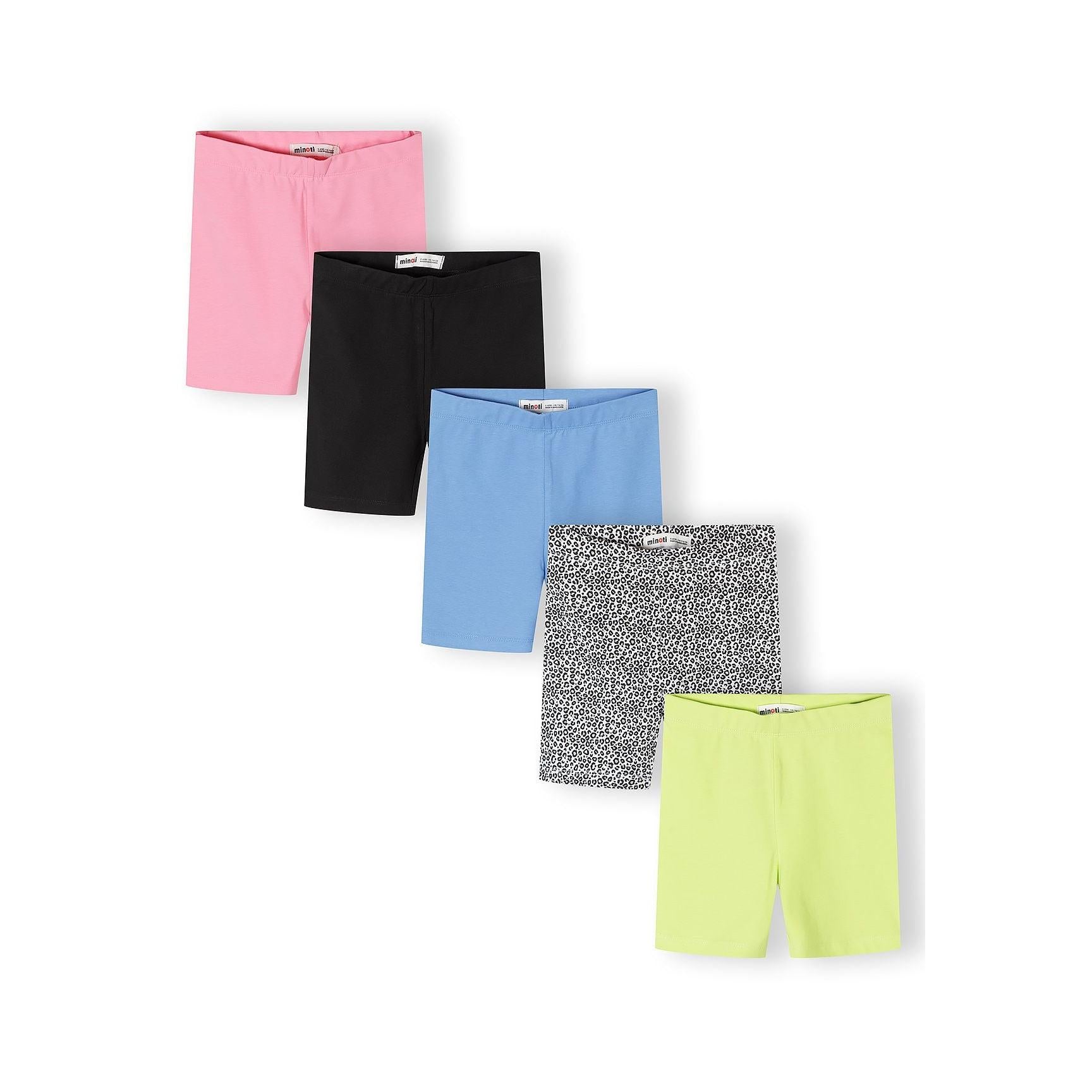 Single pair of cycling shorts in white and black leopard print pattern laid flat against white background, showing Minoti brand label