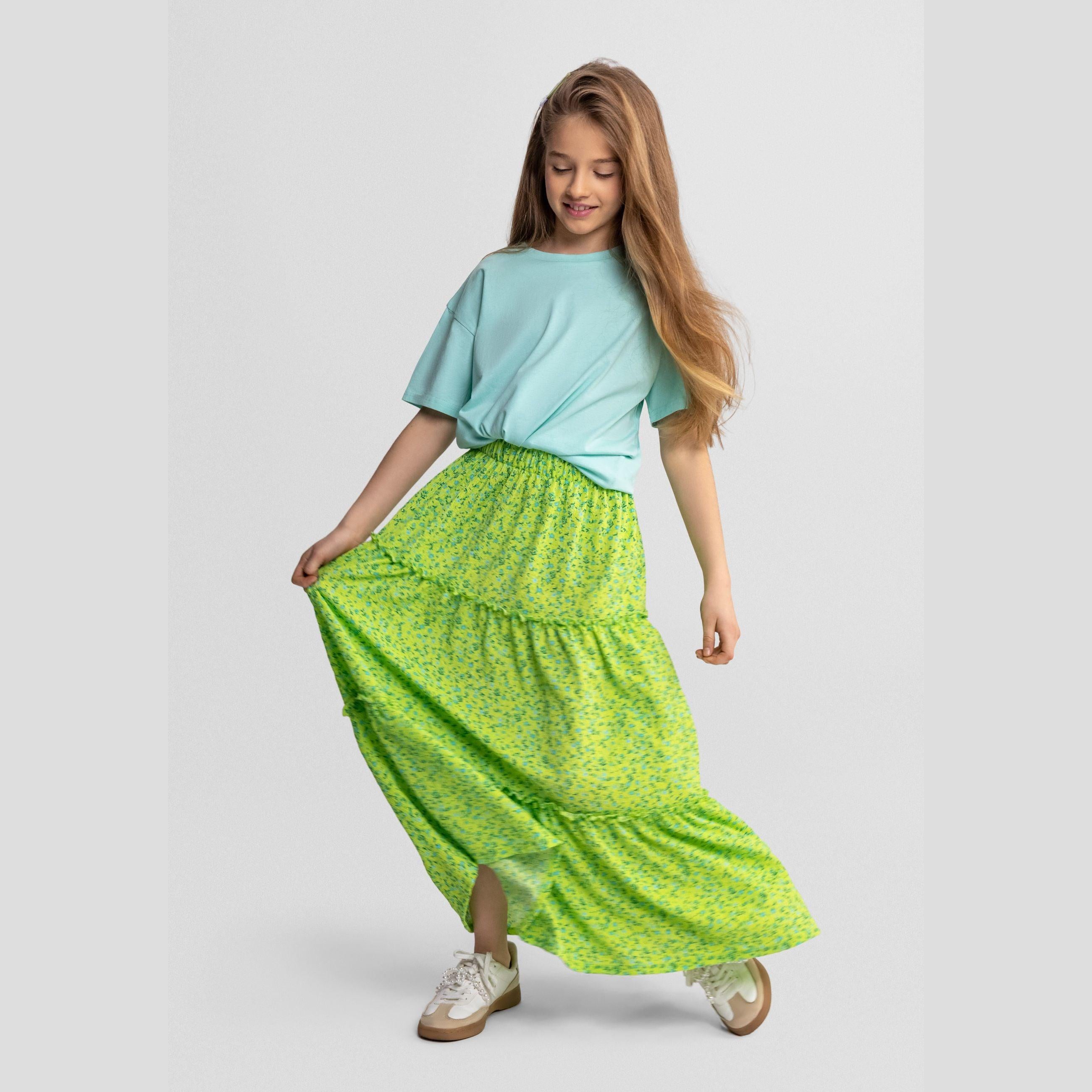 Green floral maxi skirt laid flat showing full length tiered design with elasticated waistband and delicate blue floral print
