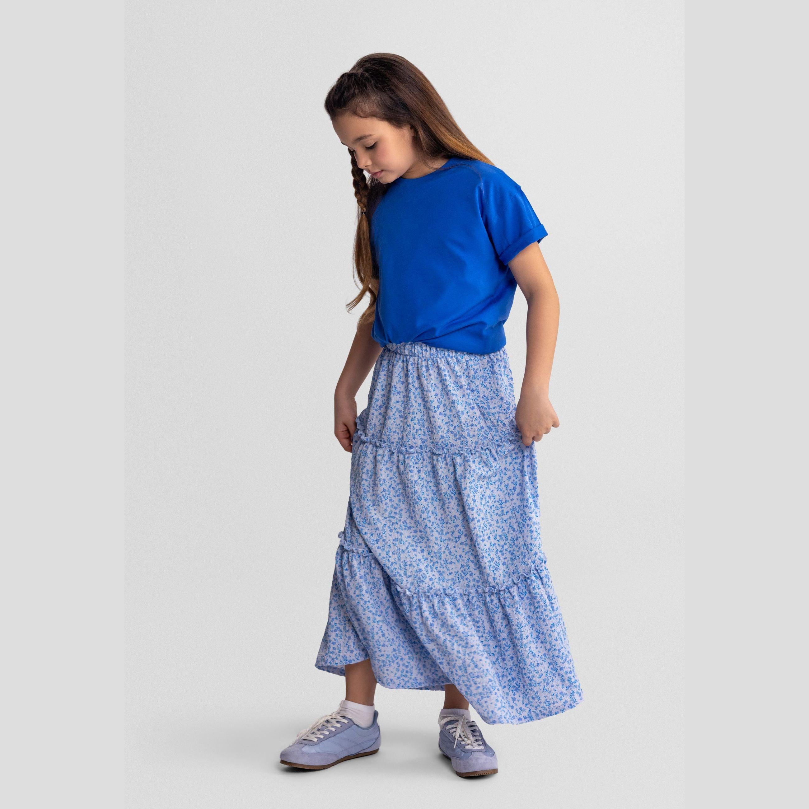 Blue floral tiered maxi skirt laid flat showing elasticated waistband and three-tier design on white background