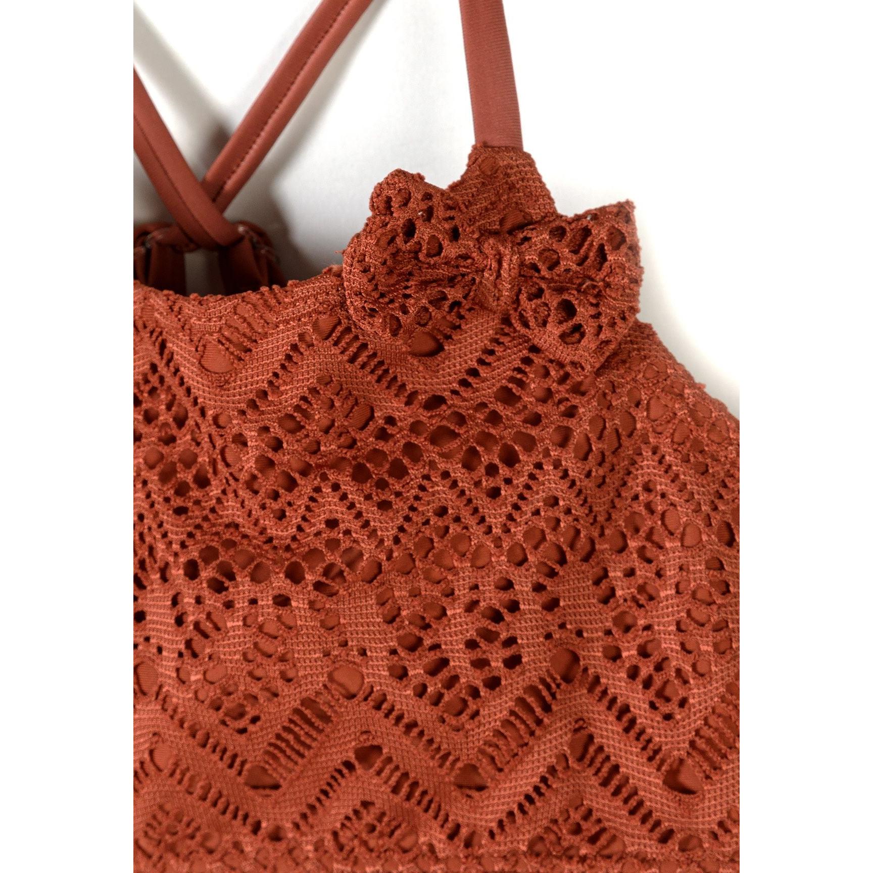 Close-up detail of copper crochet bikini showing intricate diamond and geometric lace pattern with gold charm detail on adjustable strap