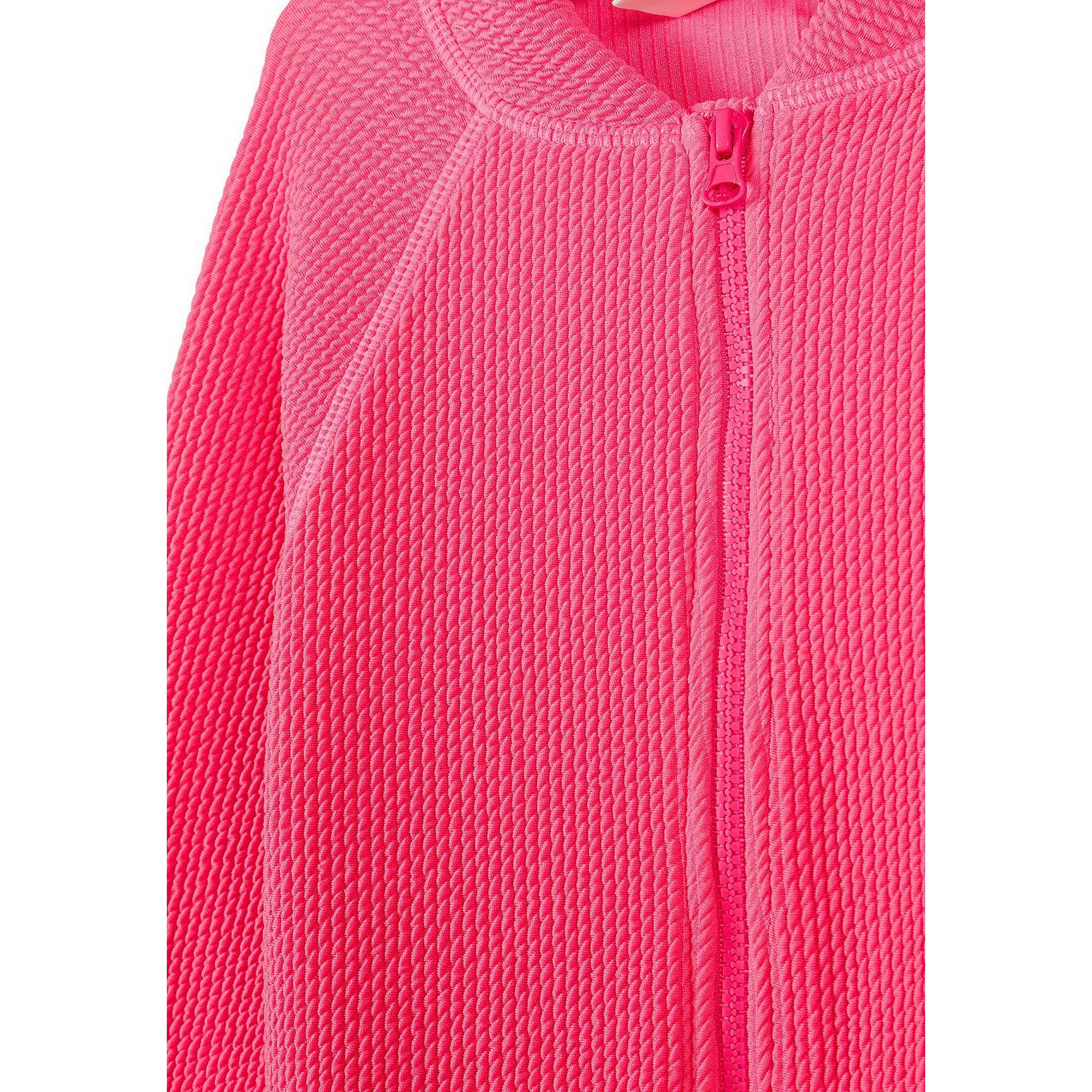Close-up detail of bright pink ribbed swimsuit fabric texture showing the zip closure and diagonal ribbed pattern