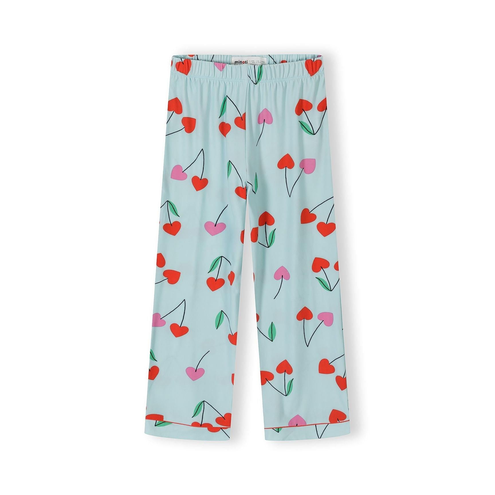 Detail shot of light blue pajama top showing Minoti label, red piping trim, cherry print pattern and button closure