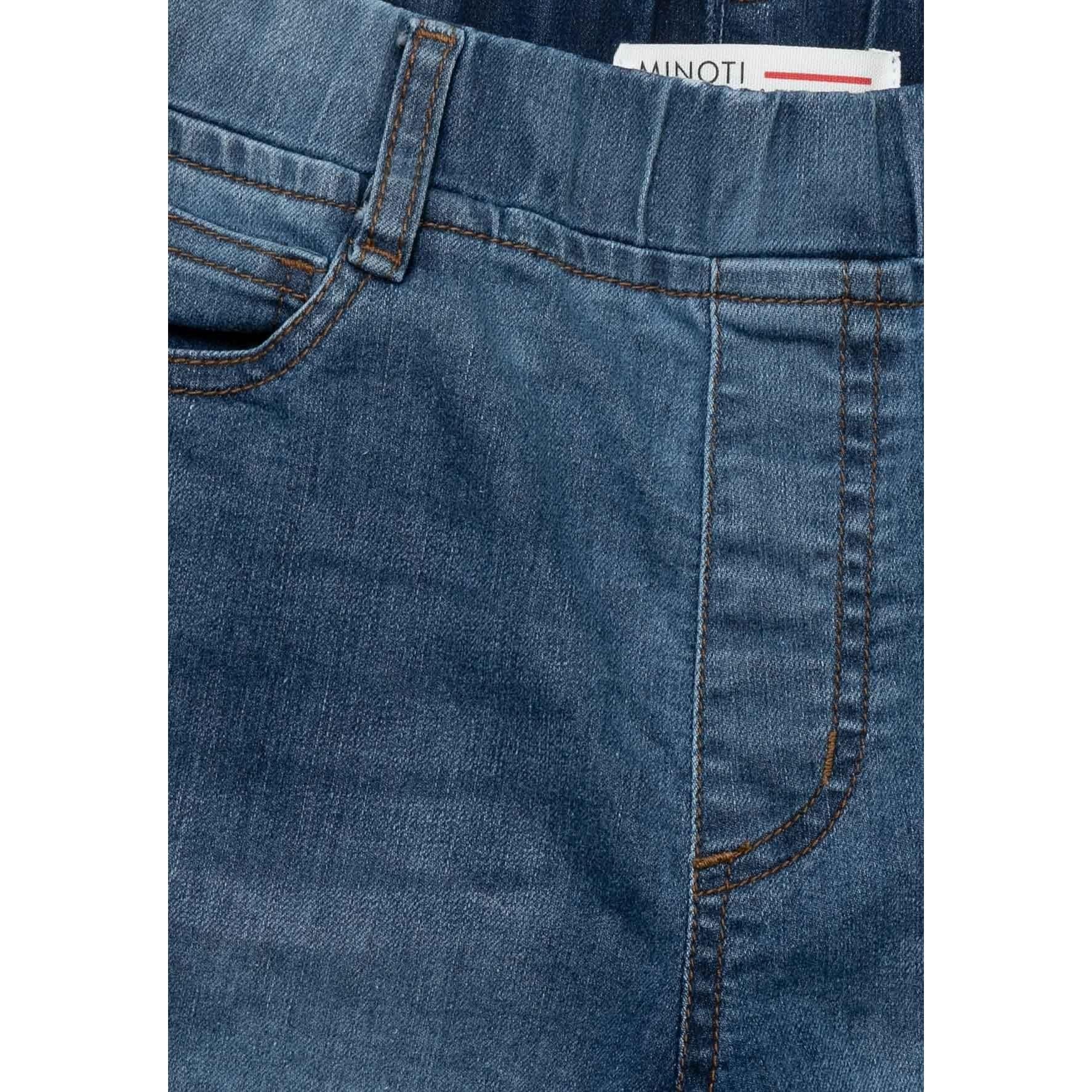 Close-up detail of front pocket and waistband showing Minoti label on light blue denim shorts