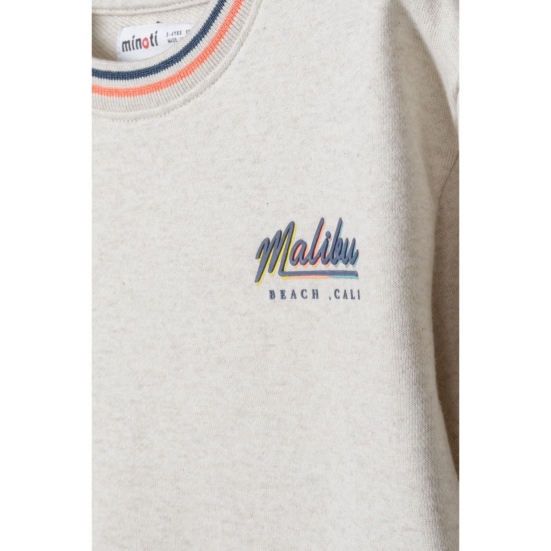 Close-up detail of Malibu Beach Cali chest print in navy and orange retro lettering on beige sweatshirt fabric, showing Minoti label at neckline