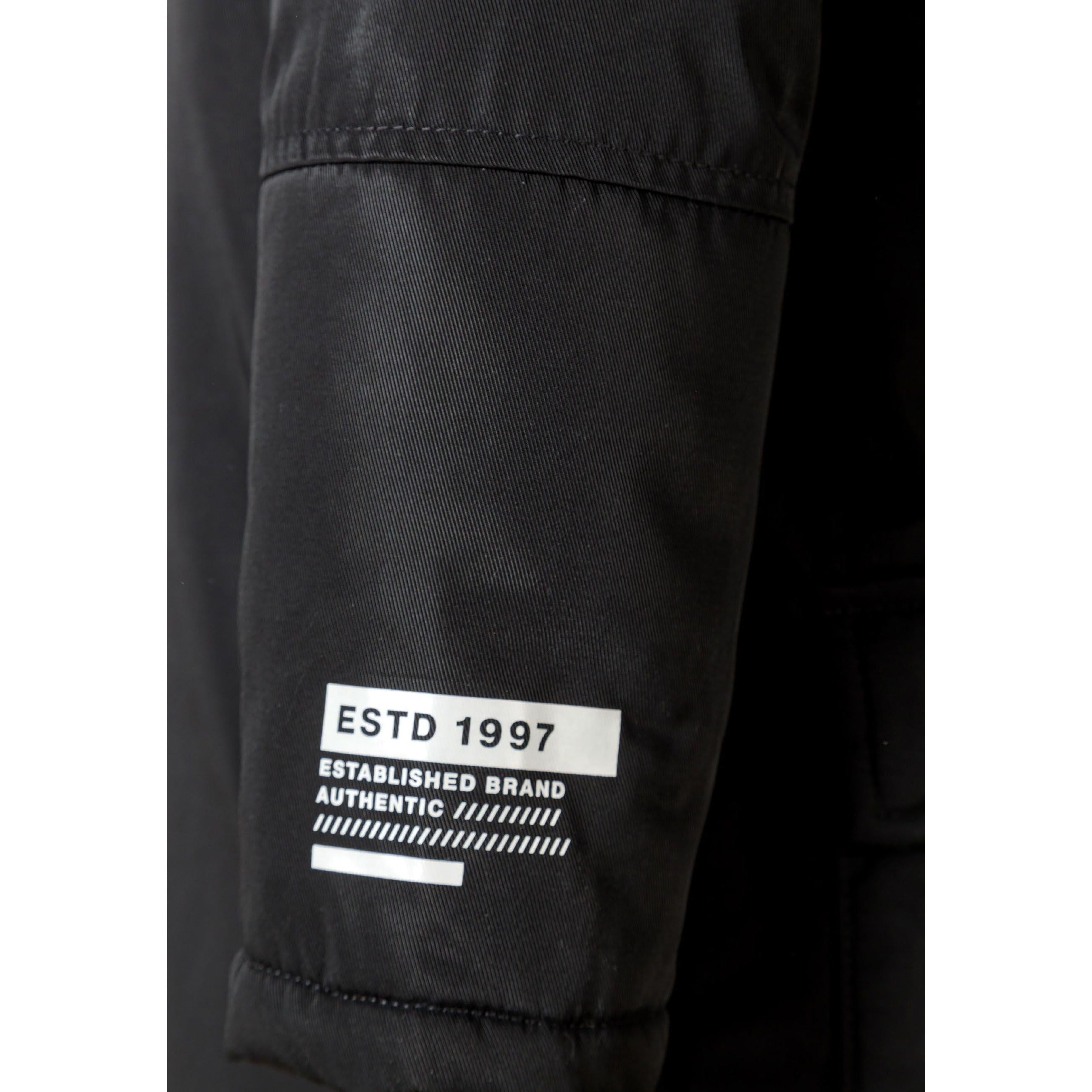 Close-up detail of black parka hood with grey faux fur trim showing attachment buttons and fabric texture