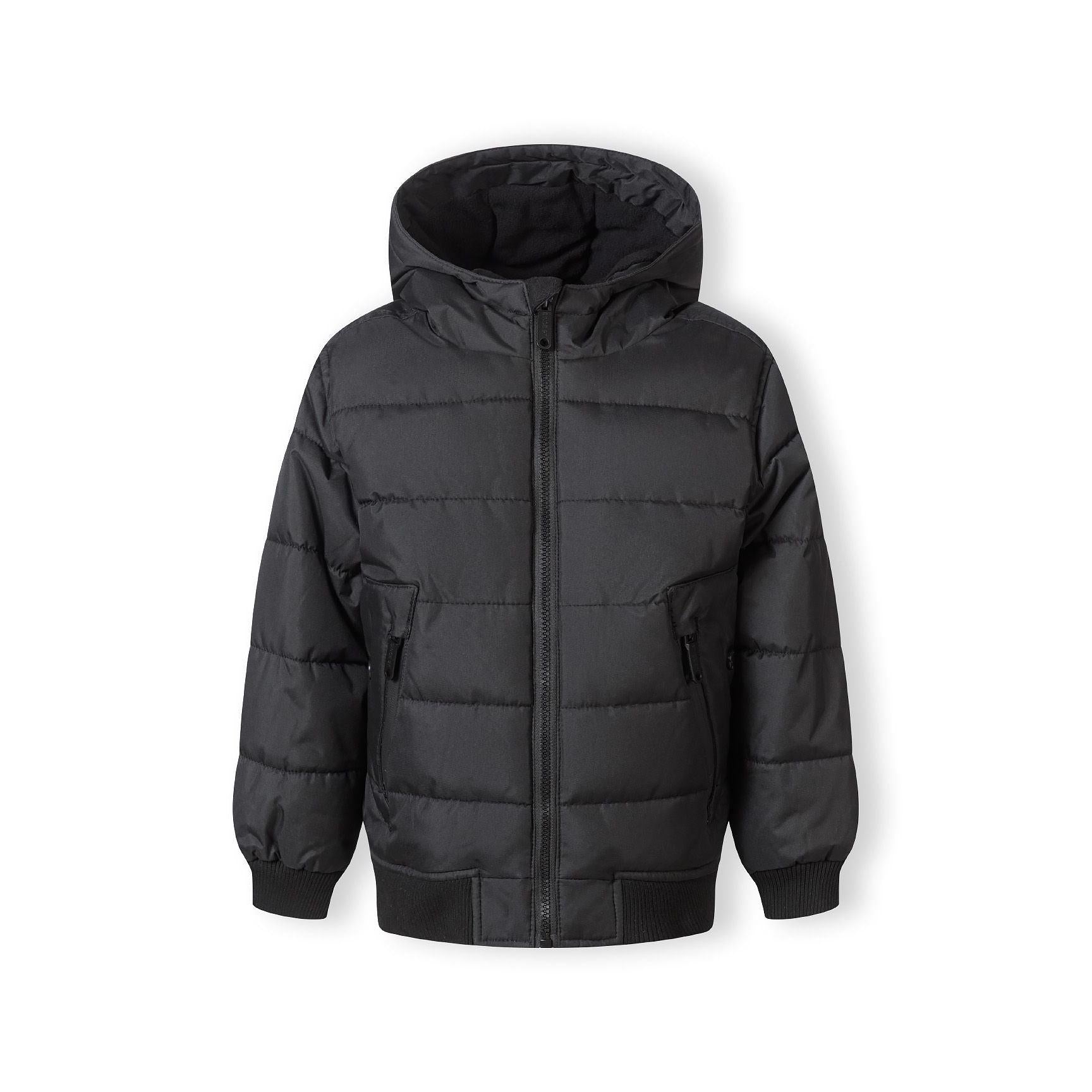 Same boy in black padded jacket showing front view of the quilted design and hood detail against white background