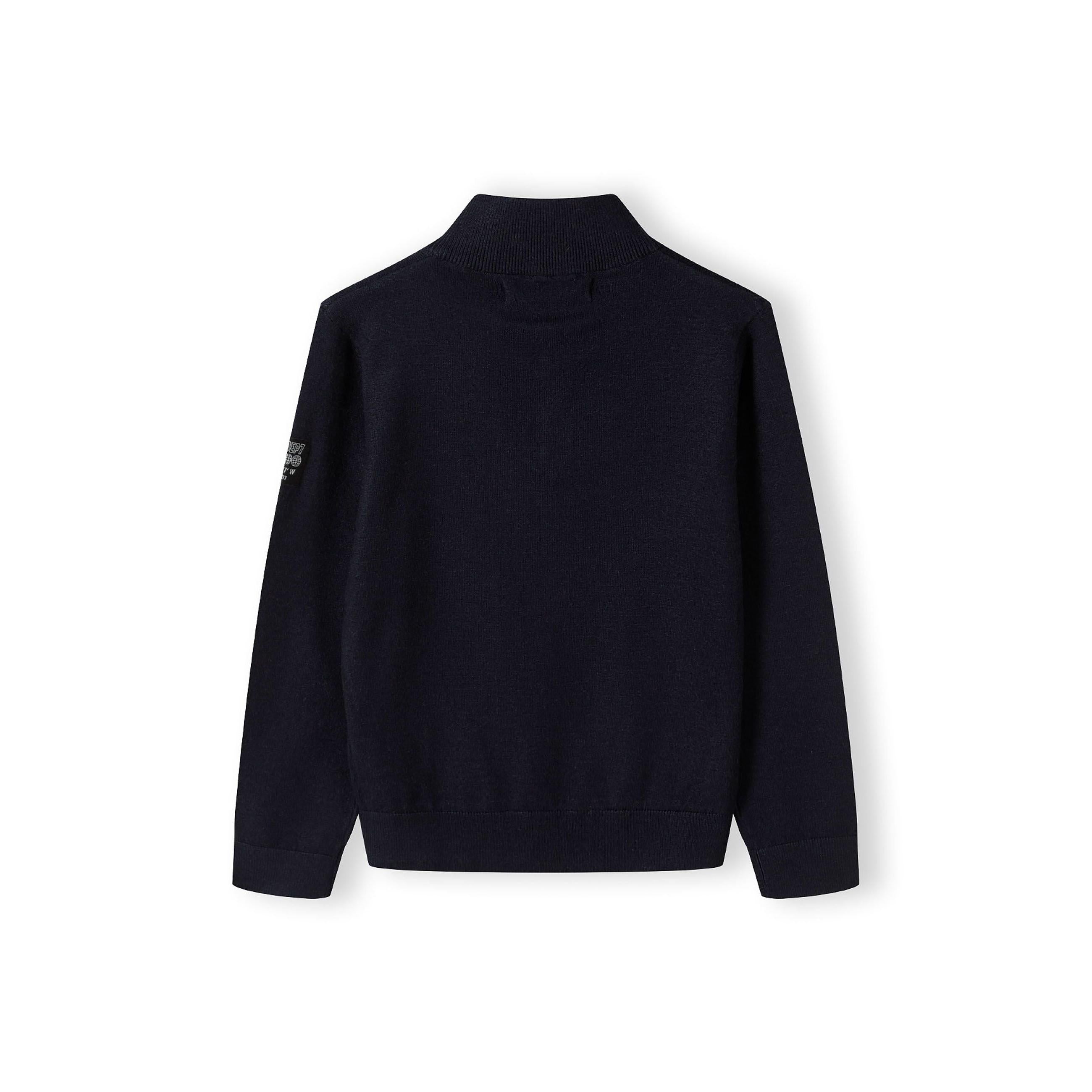 Navy half-zip jumper laid flat showing back view with stand collar and ribbed cuffs on white background