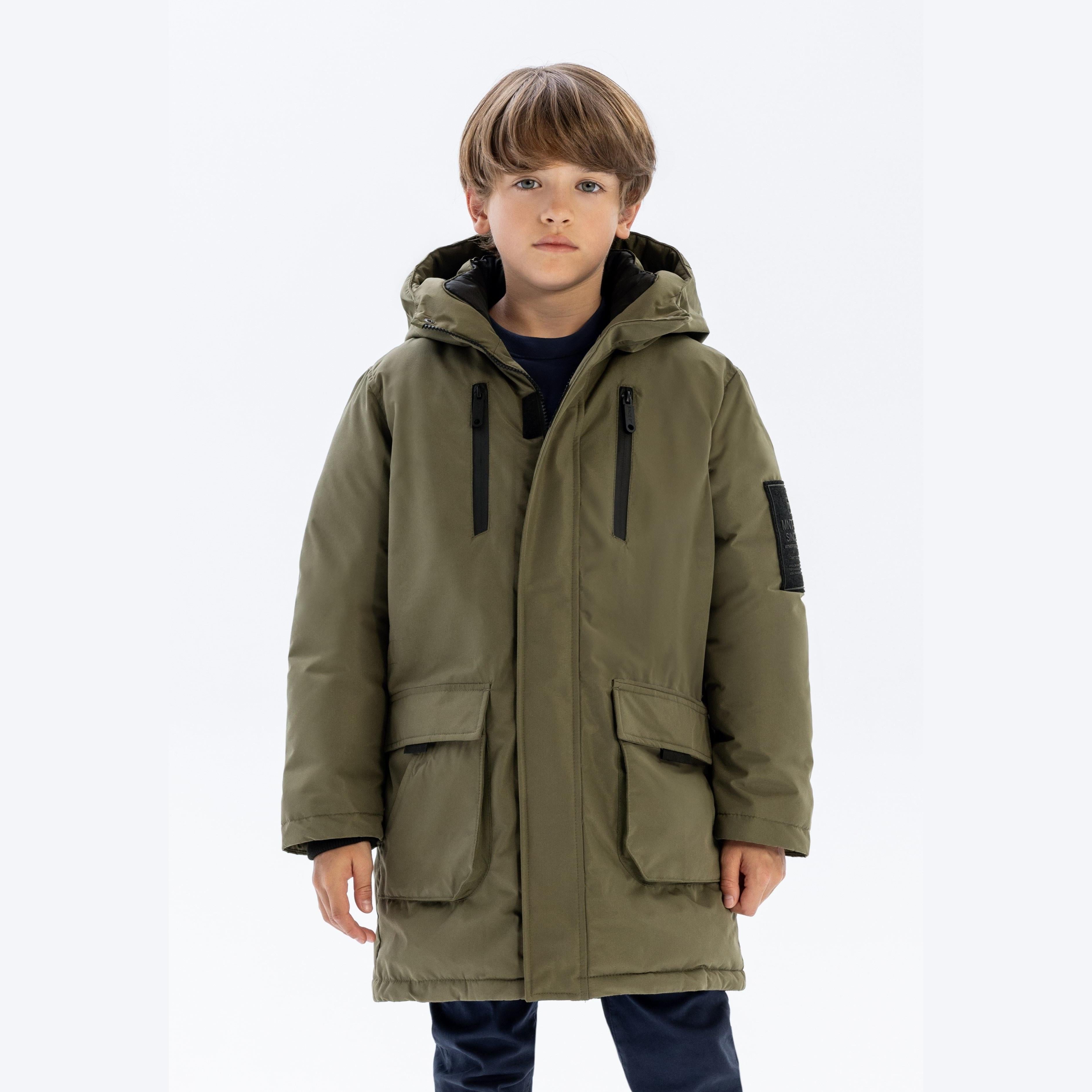 Boy wearing khaki utility jacket with black hood lining, front view on white background