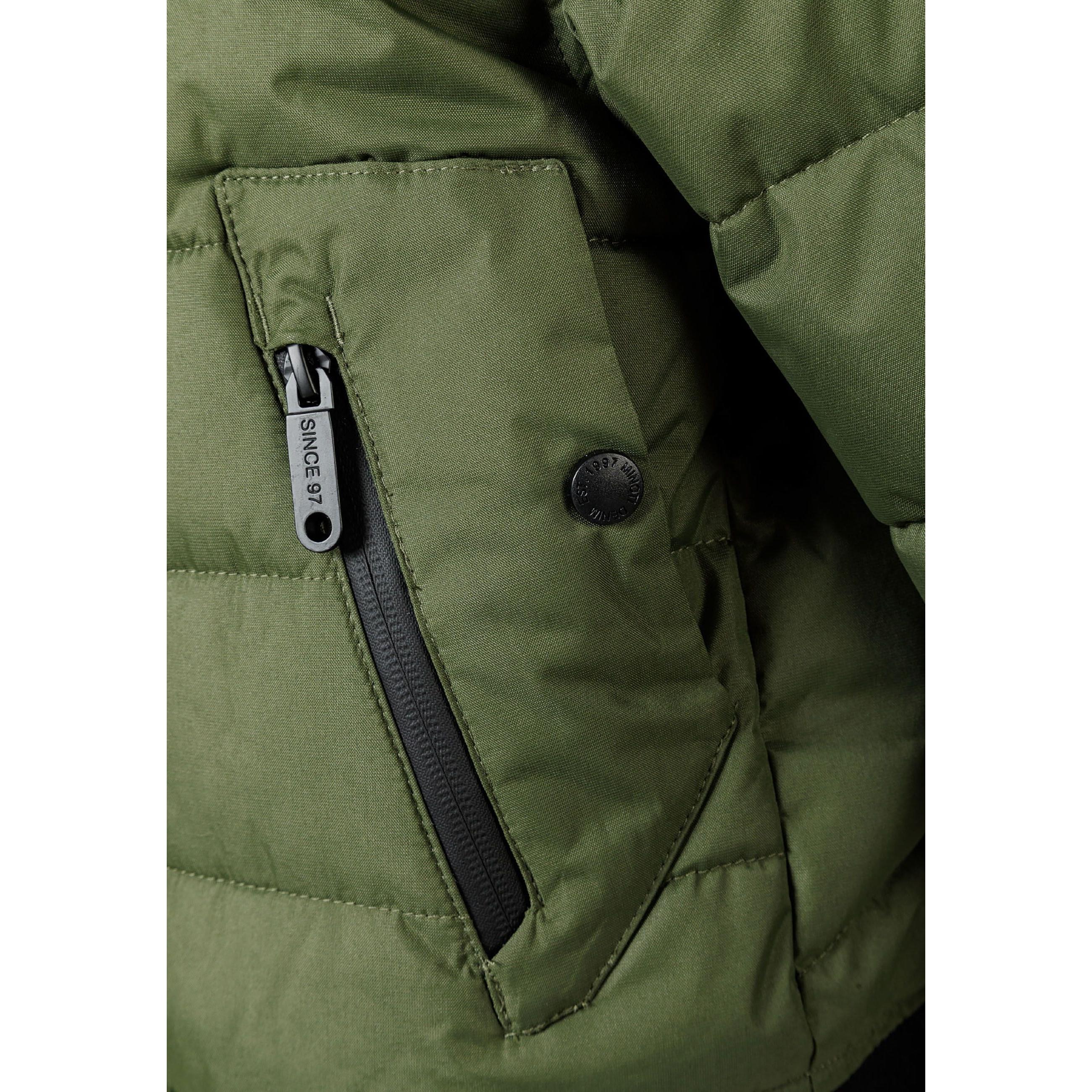Close-up detail of khaki padded jacket showing circular black Minoti brand badge with crossed design and number 97