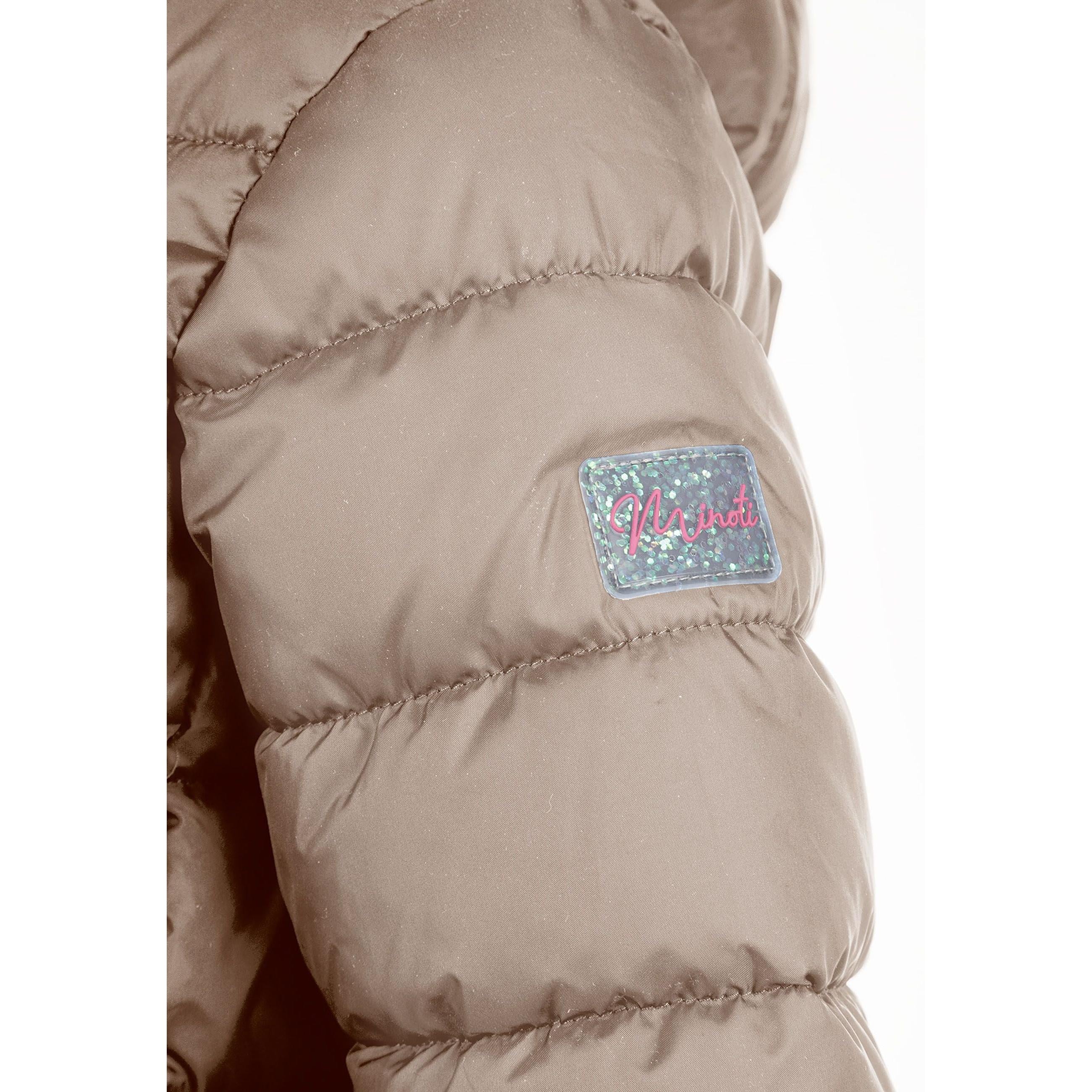 Detailed view of beige quilted jacket construction showing padded panels, zip mechanism and hood design elements, soft neutral lighting