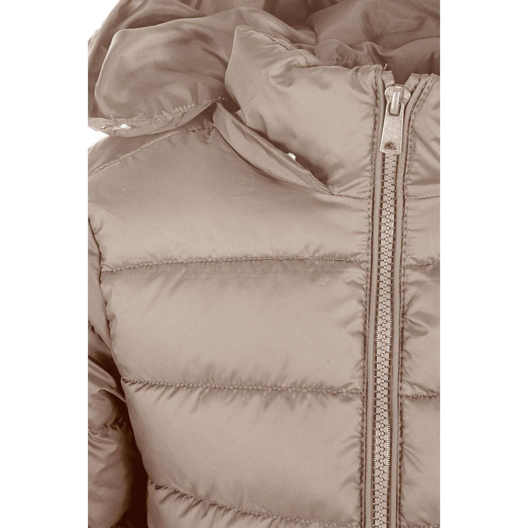 Detailed view of beige quilted jacket construction showing padded panels, zip mechanism and hood design elements, soft neutral lighting