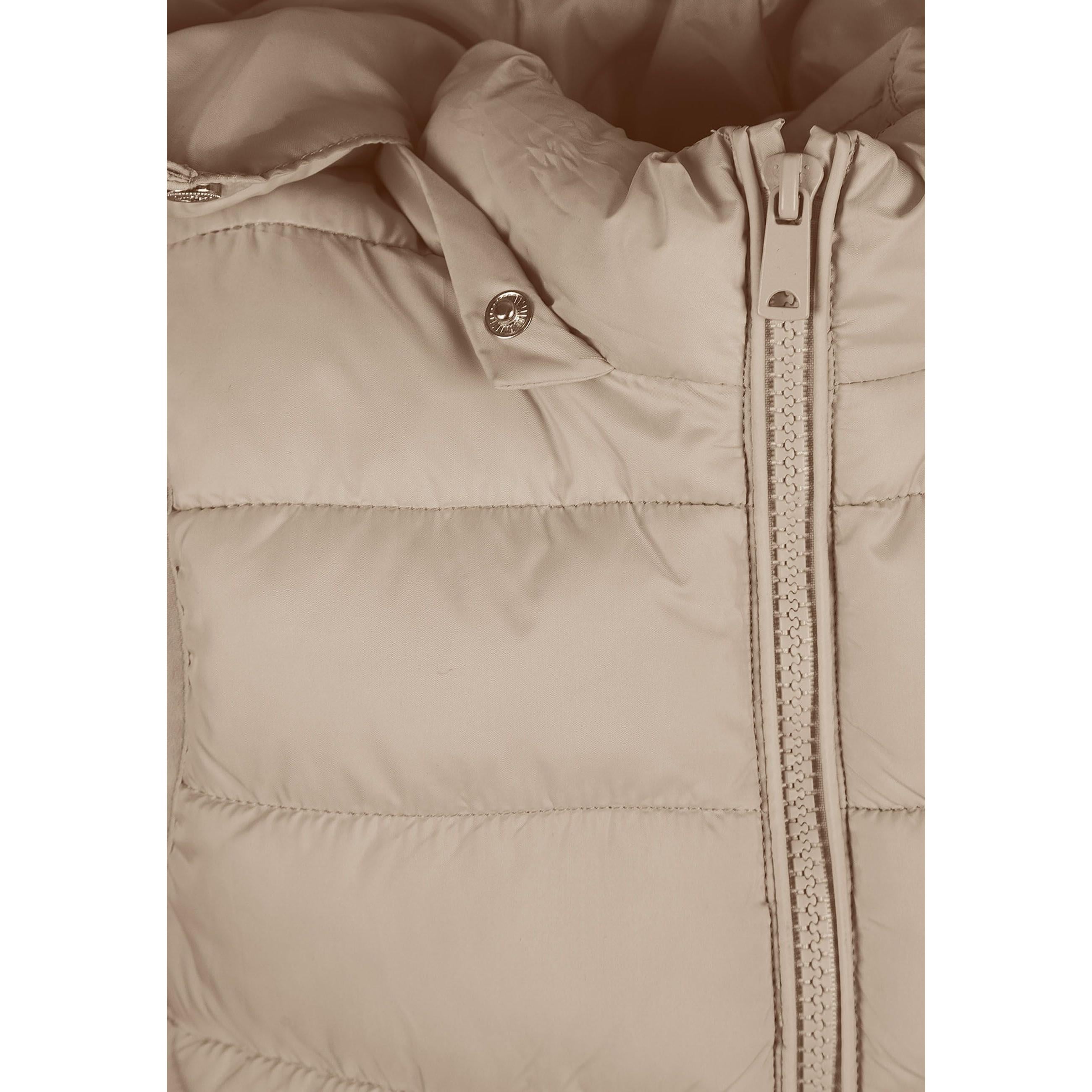 Close-up detail of beige quilted fabric showing horizontal stitching lines and Minoti brand label with pink lettering