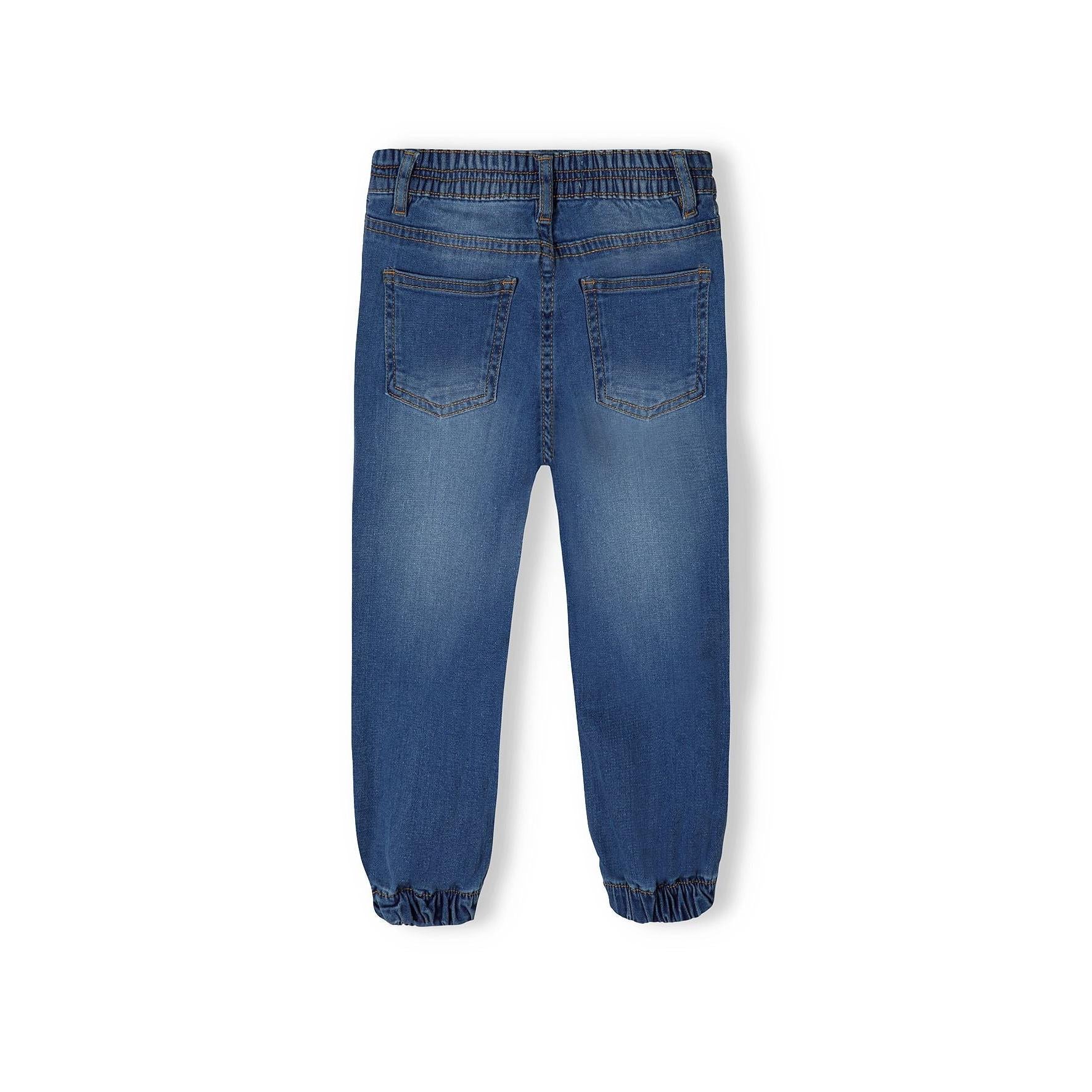 Back view of navy denim jogger jeans on white background displaying rear pockets and elasticated waistband detail
