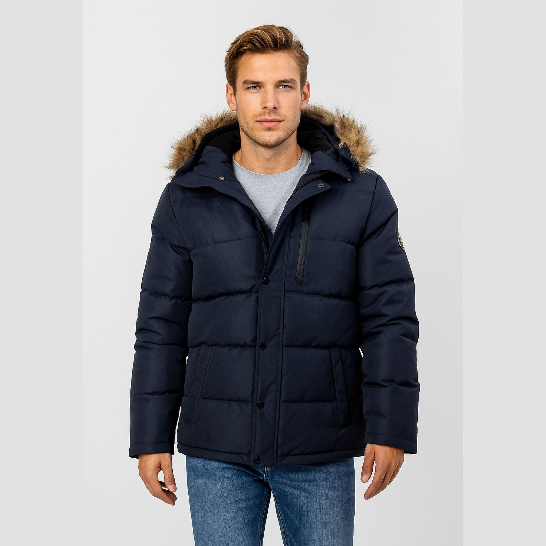 Man wearing navy quilted winter jacket with faux fur hood, front view on white background